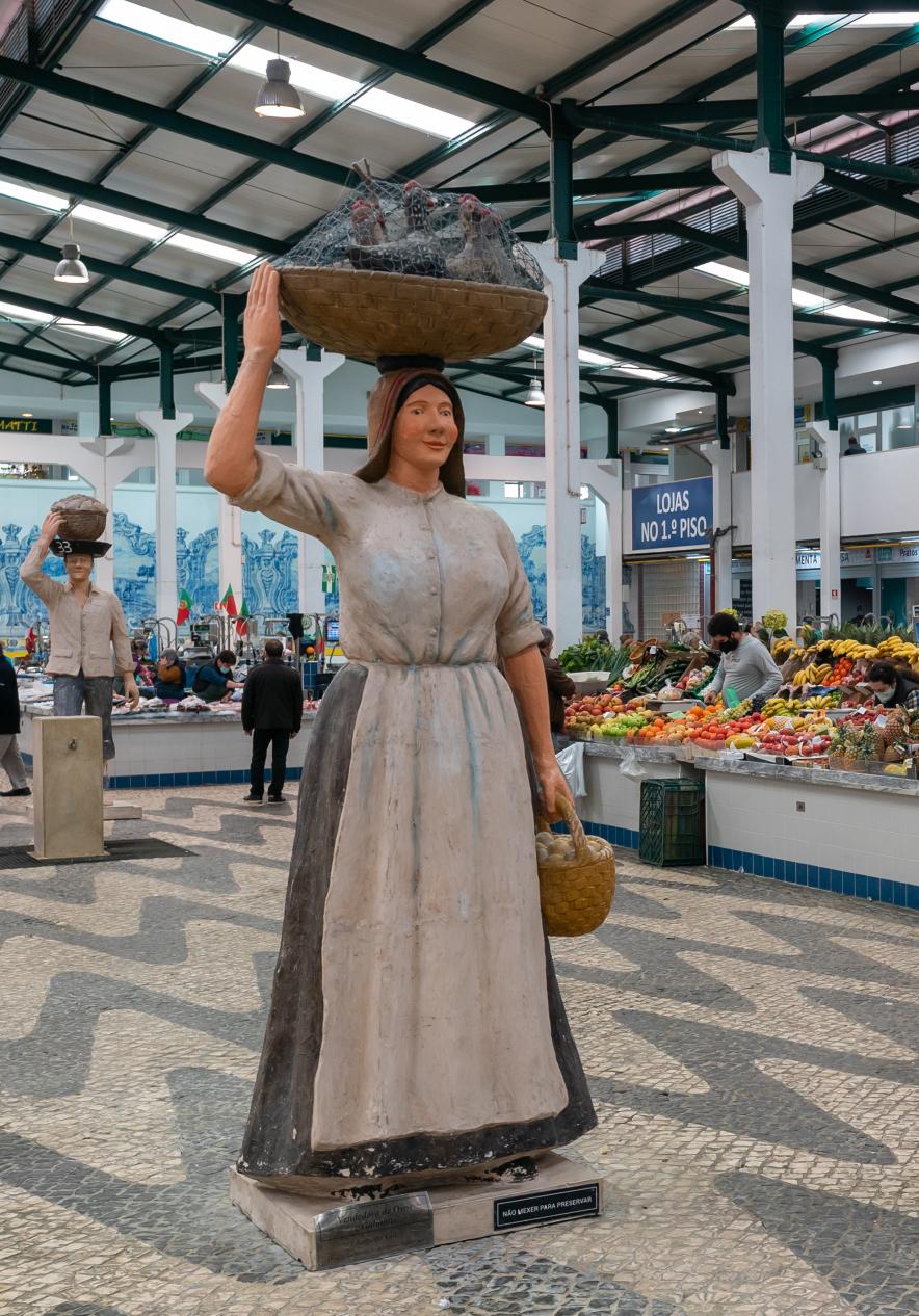 Mercado em Setúbal, com uma figura de uma senhora com um cesto de peixe em cima da cabeça
