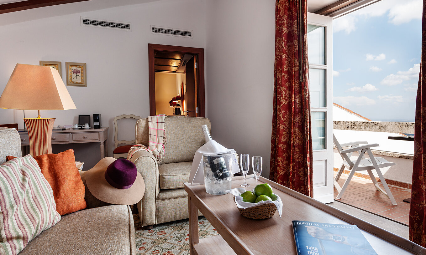 Die Superior Suite mit Balkon der Pousada Marvão hat ein Wohnzimmer mit Sesseln und Balkon