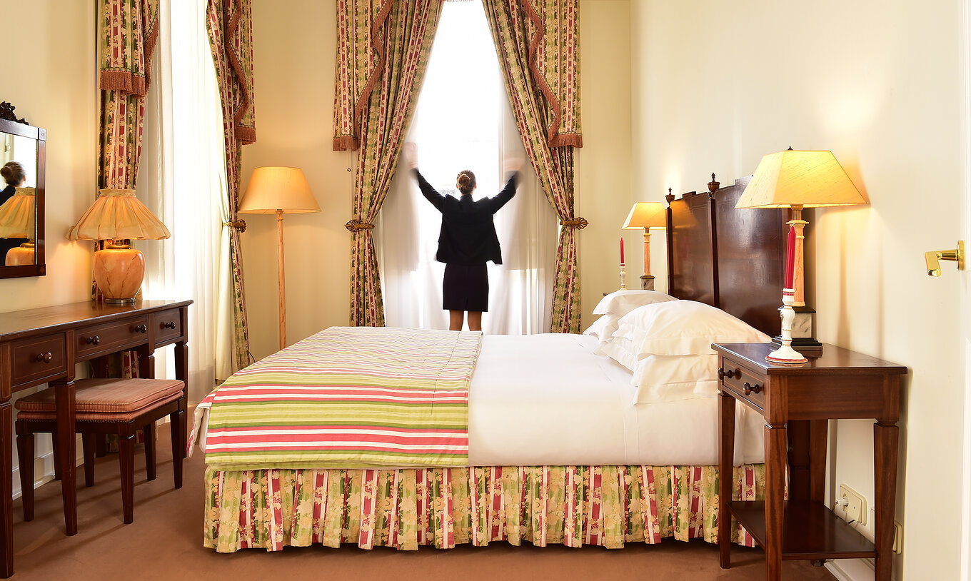 Das Familienzimmer der Pousada Palácio Queluz hat Platz mit einem Doppelbett, einem Möbel und Vorhängen