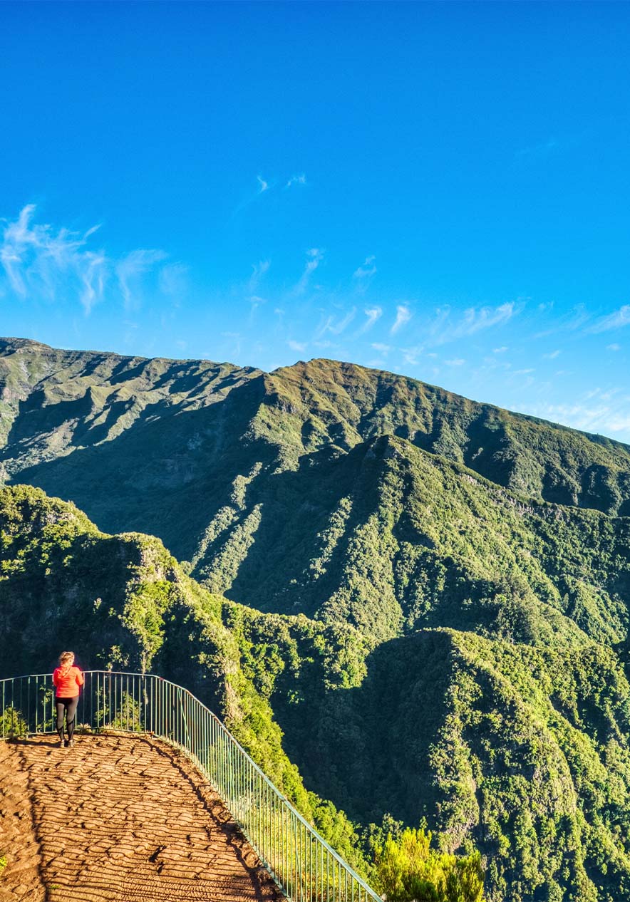 Wanderweg in Madeira nahe Pestana Casino Park, Hotel 5 Estrelas no Centro do Funchal mit Bergblick unter blauem Himmel