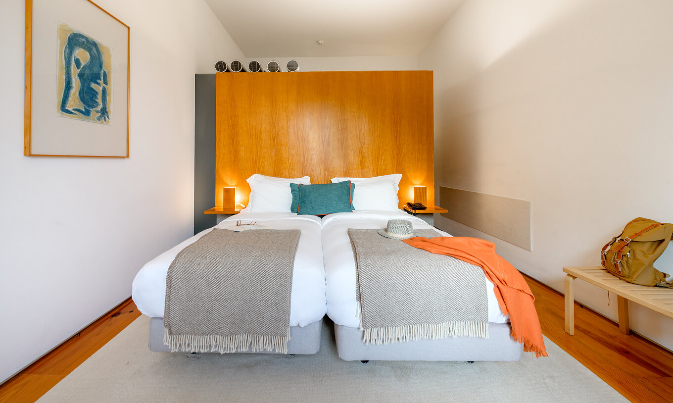 Das Klassische Zimmer der Pousada Mosteiro Amares hat zwei getrennte Betten mit einer hohen Holz Kopfteil und blauen Kissen