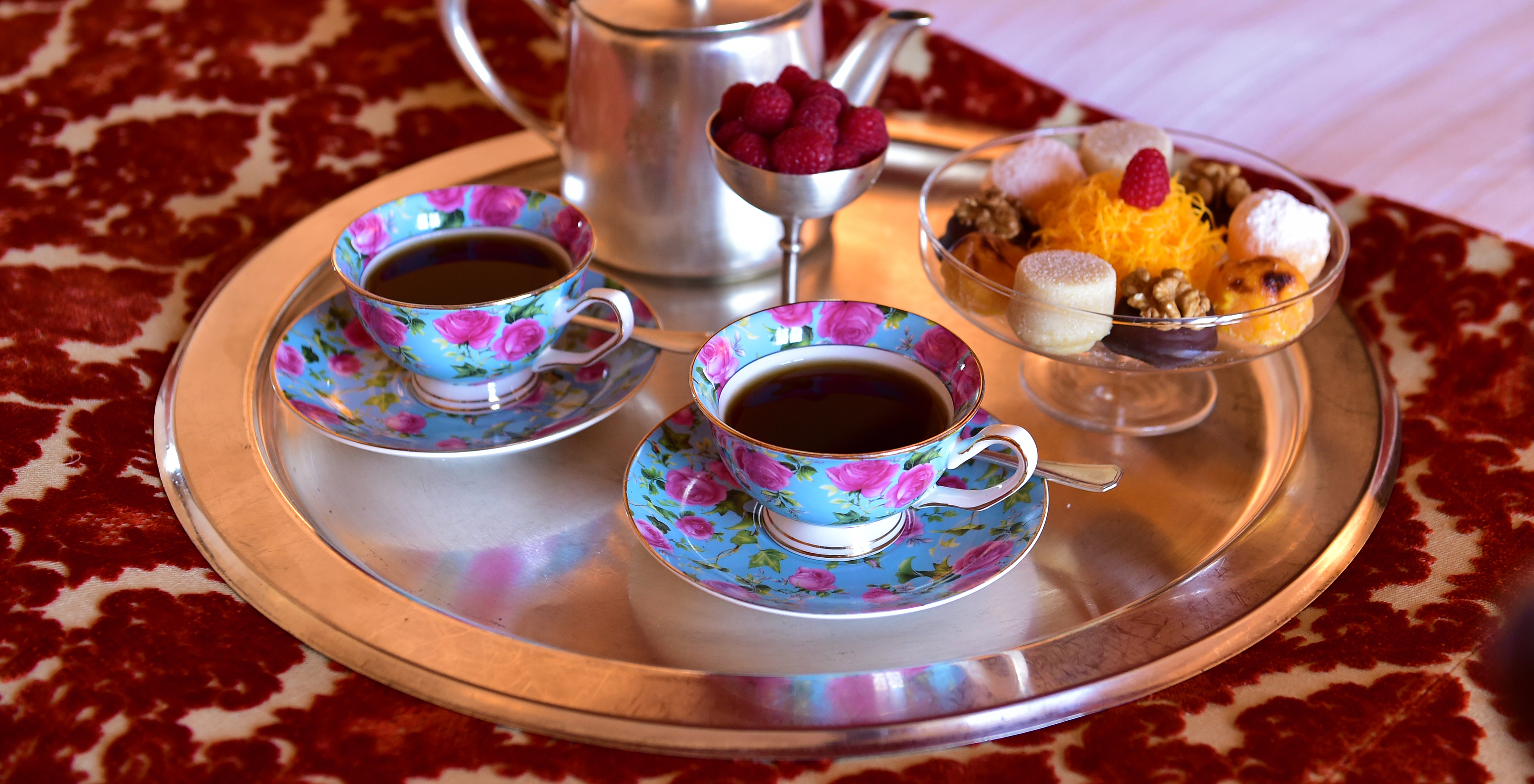 The Classic Room of The Pousada Valença has a room service tray with tea, fruit, and cookies