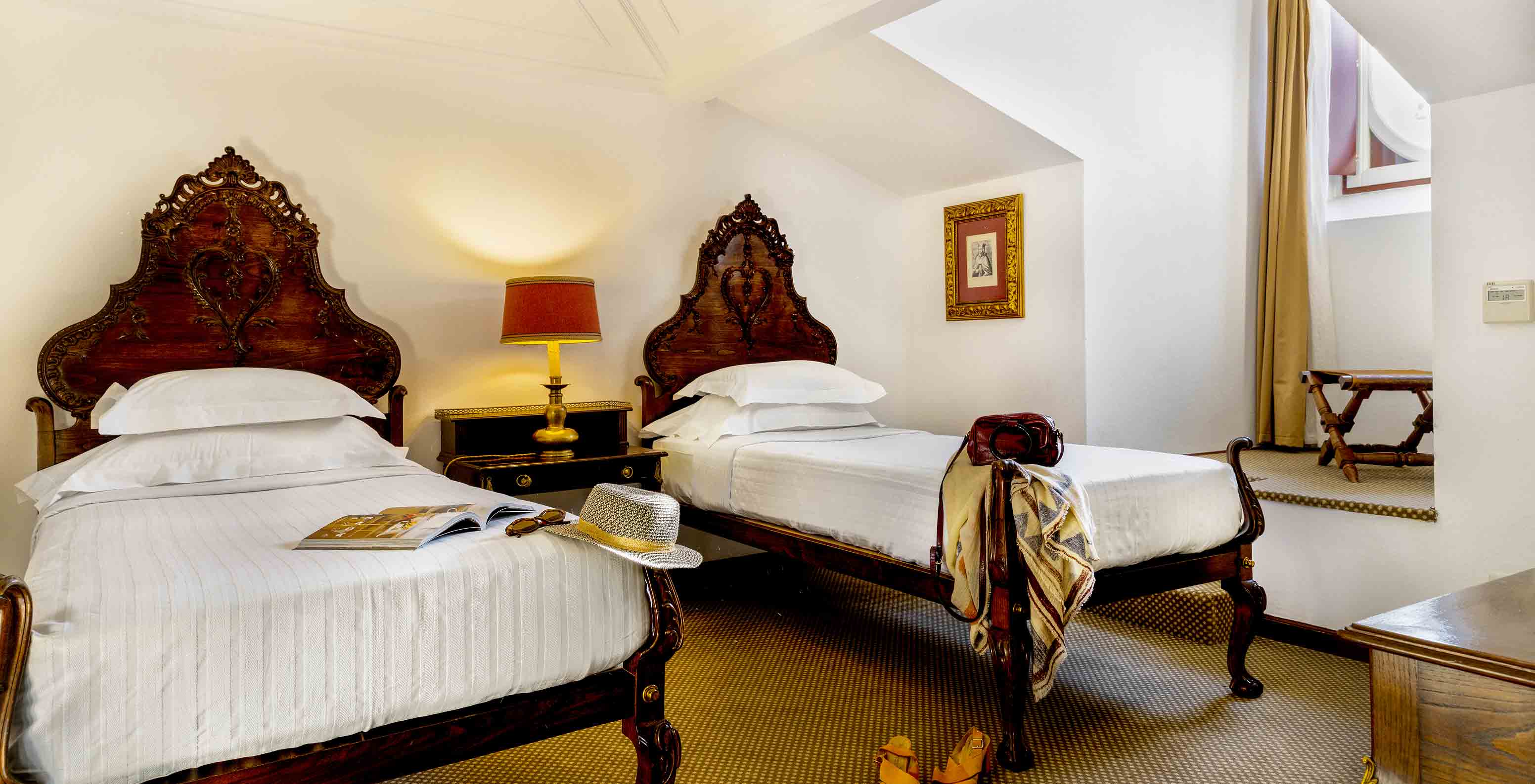 The Classic Room has two single beds and a bedside table with lamp at Pousada Castelo Estremoz