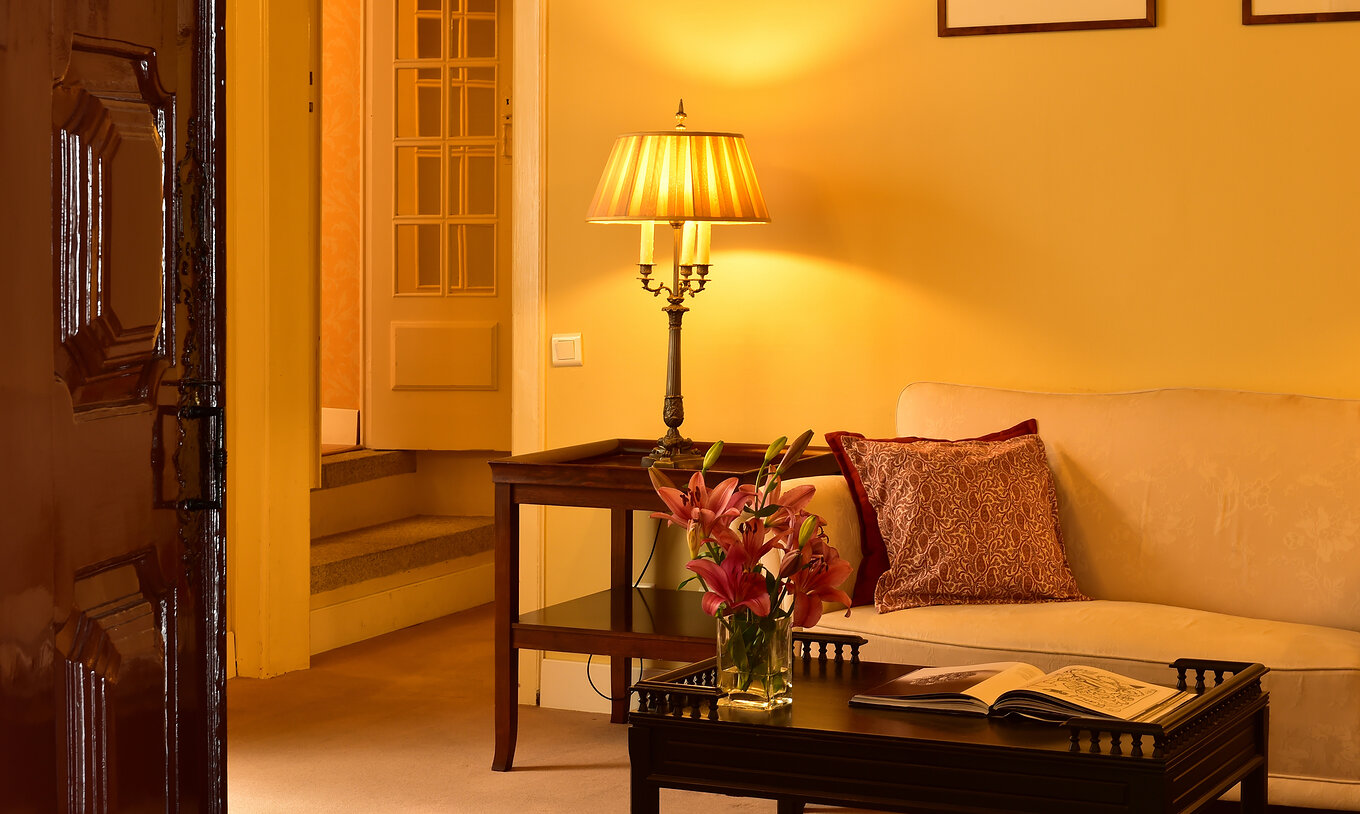 The Special Suite of The Pousada Convento Évora has a seating area with a sofa and a table with flowers