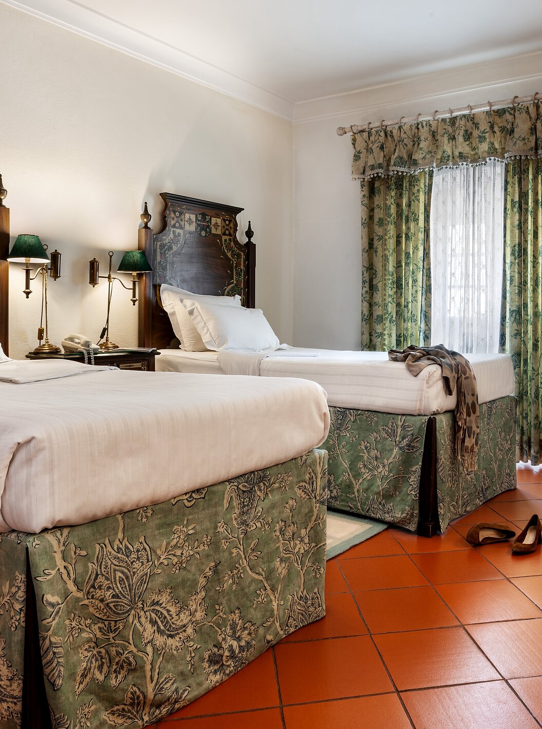 The Family Suite of The Pousada Marvão features two separate beds with a floral pattern and a counter