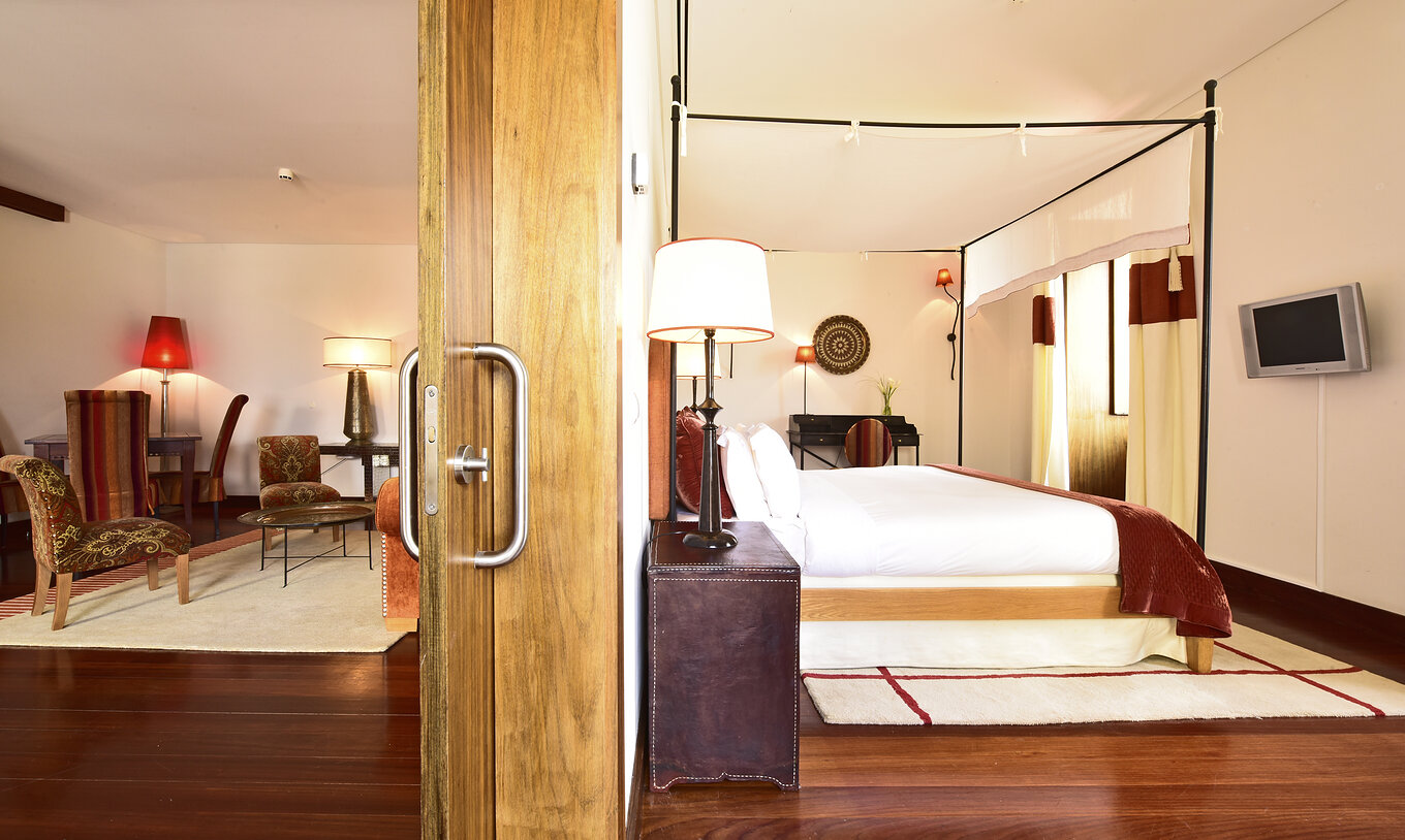 The Special Suite of The Pousada Convento Tavira has a sliding door that separates the bedroom and the living room