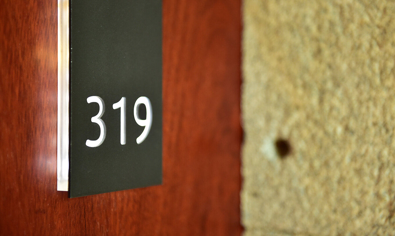 The Classic Family of the Pousada Viseu has a room door made of wood, with stone around