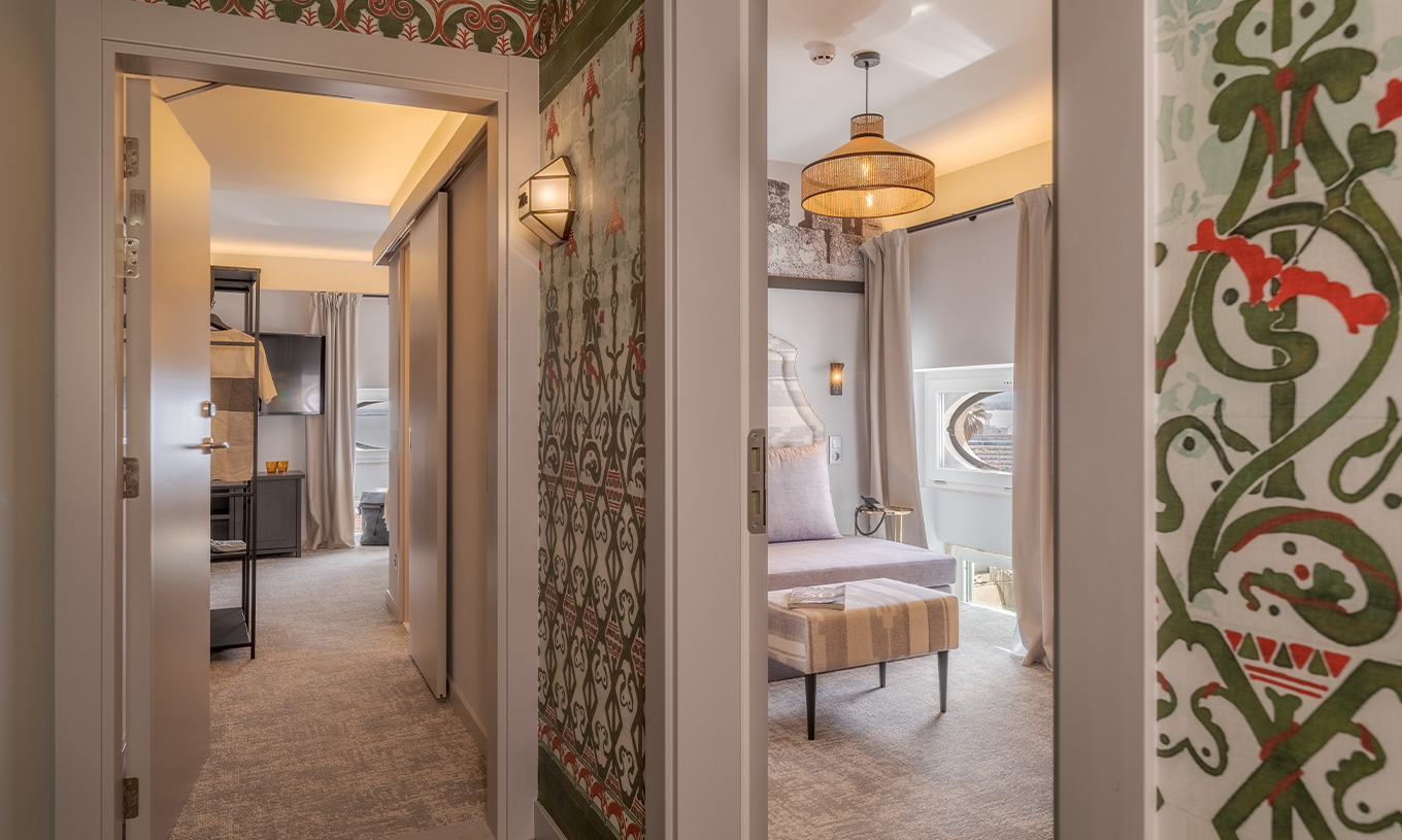 The Portas do Sol Suite at Pousada Alfama has a corridor connecting the living room and the room with the double bed