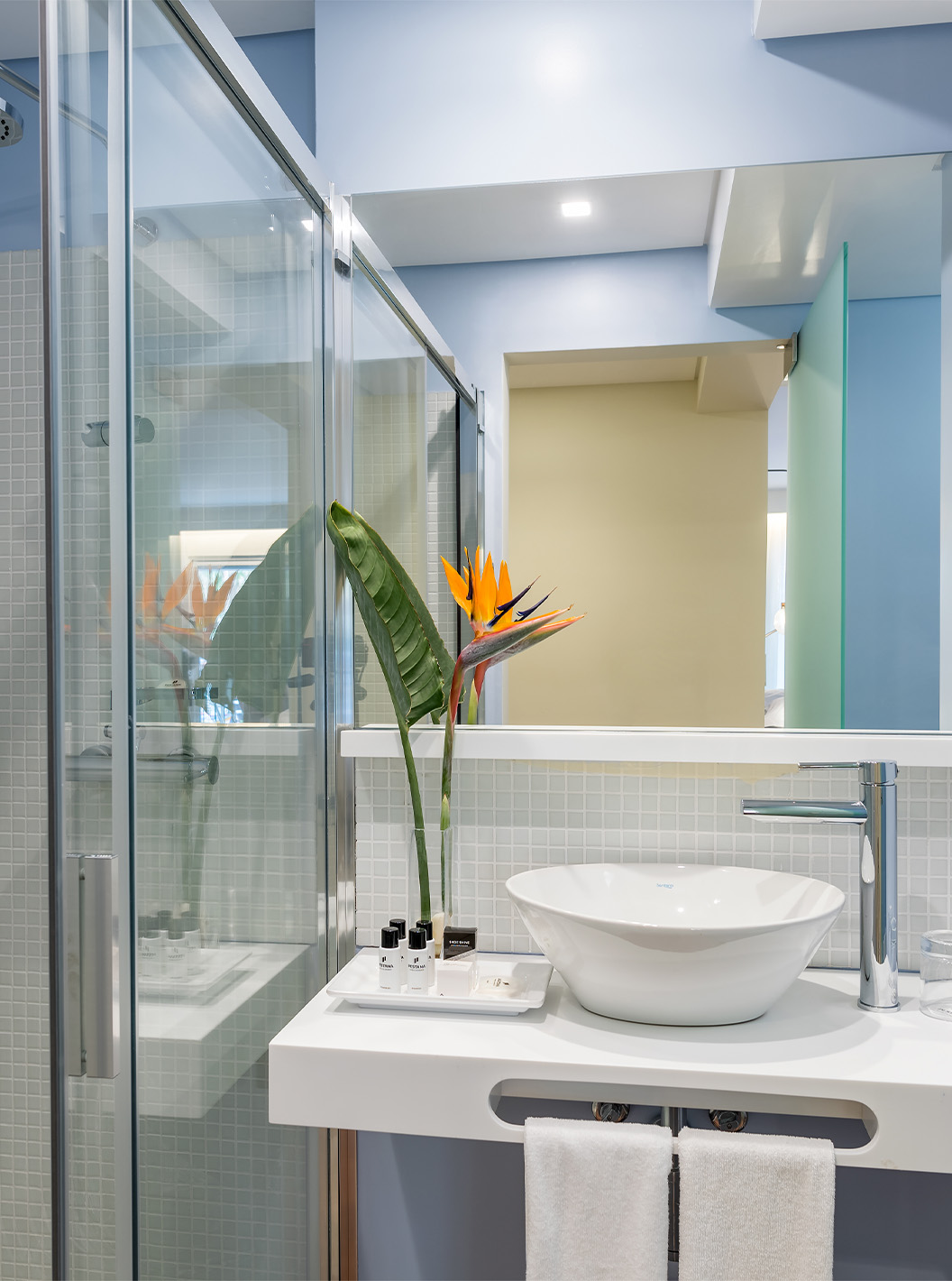 The Classic Room at Pestana Churchill Bay has a blue bathroom with amenities, a sink, and a shower