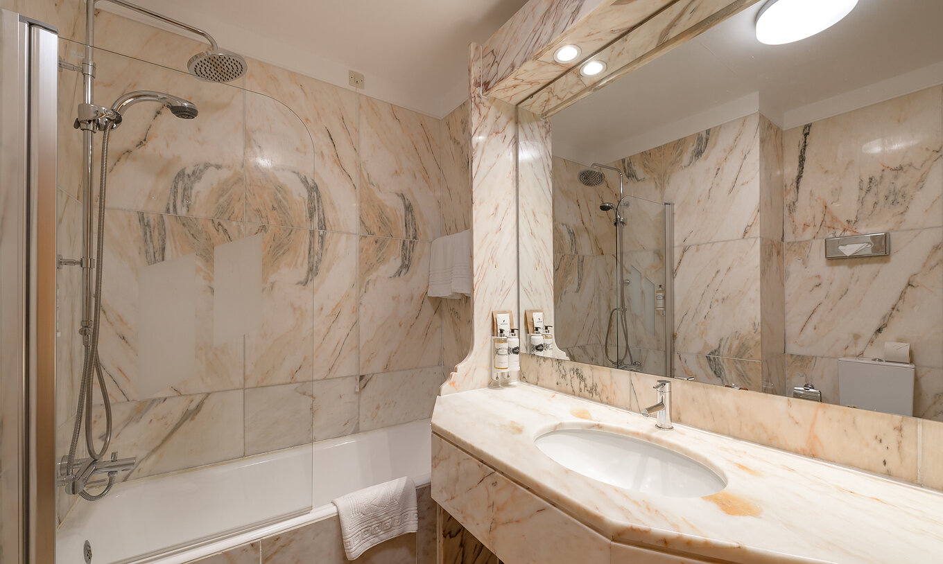 The Classic Family of The Pousada Viana do Castelo has a bathtub with a shower and a counter with a marble sink
