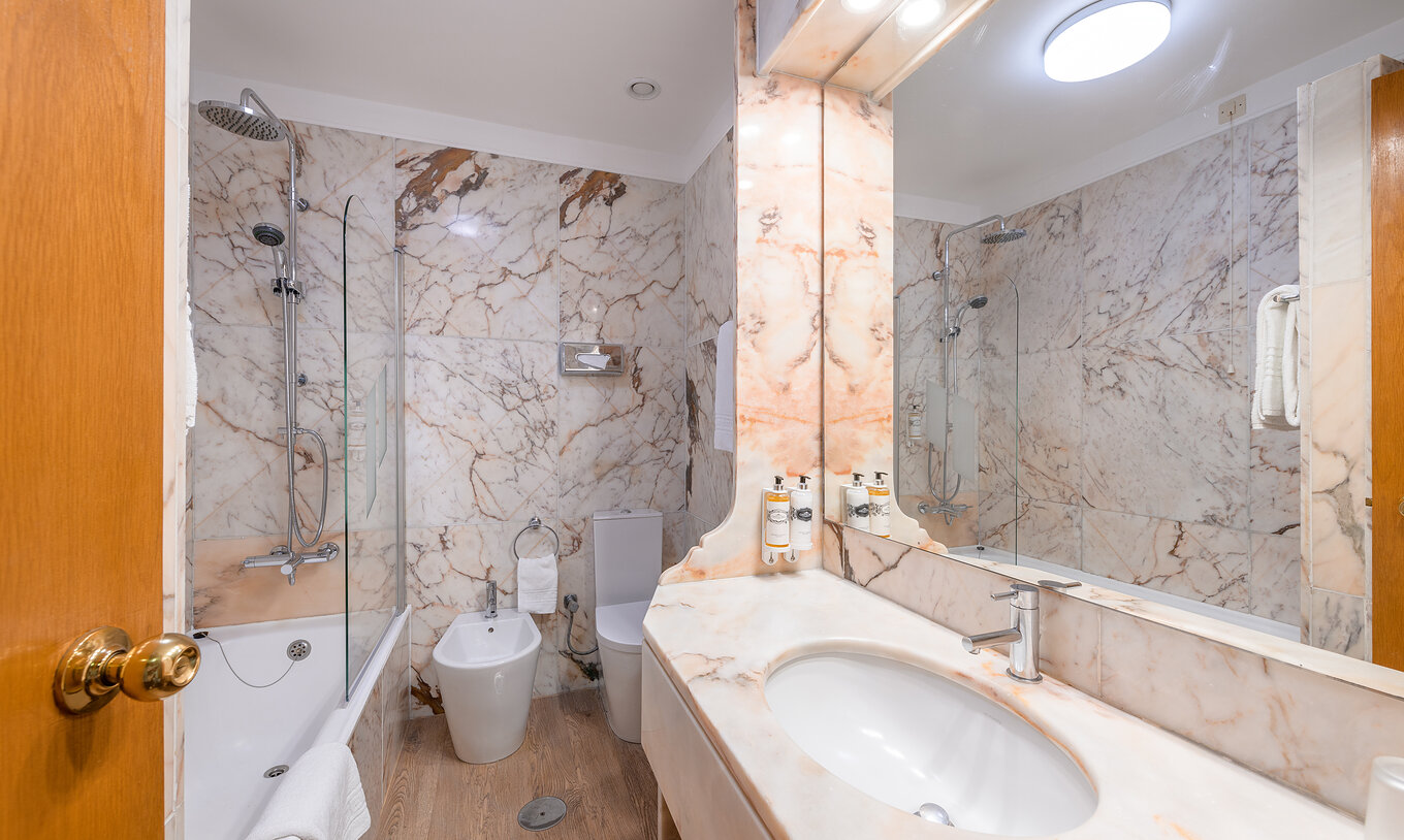 The Classic Room of The Pousada Viana do Castelo has a bathtub with a shower and a counter with a marble sink