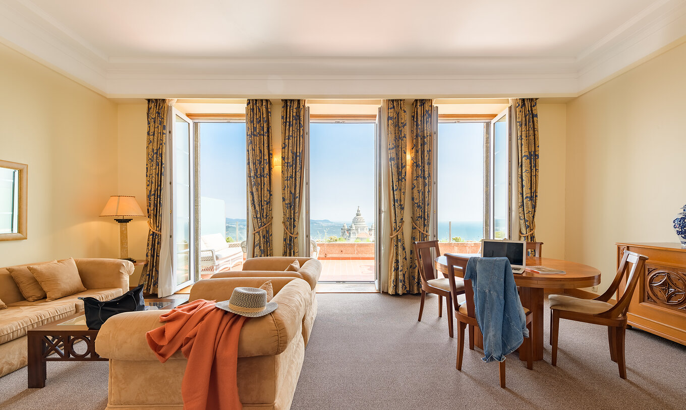The Panoramic Suite with Terrace of The Pousada Viana do Castelo has a living room with sofas, tables, and a balcony