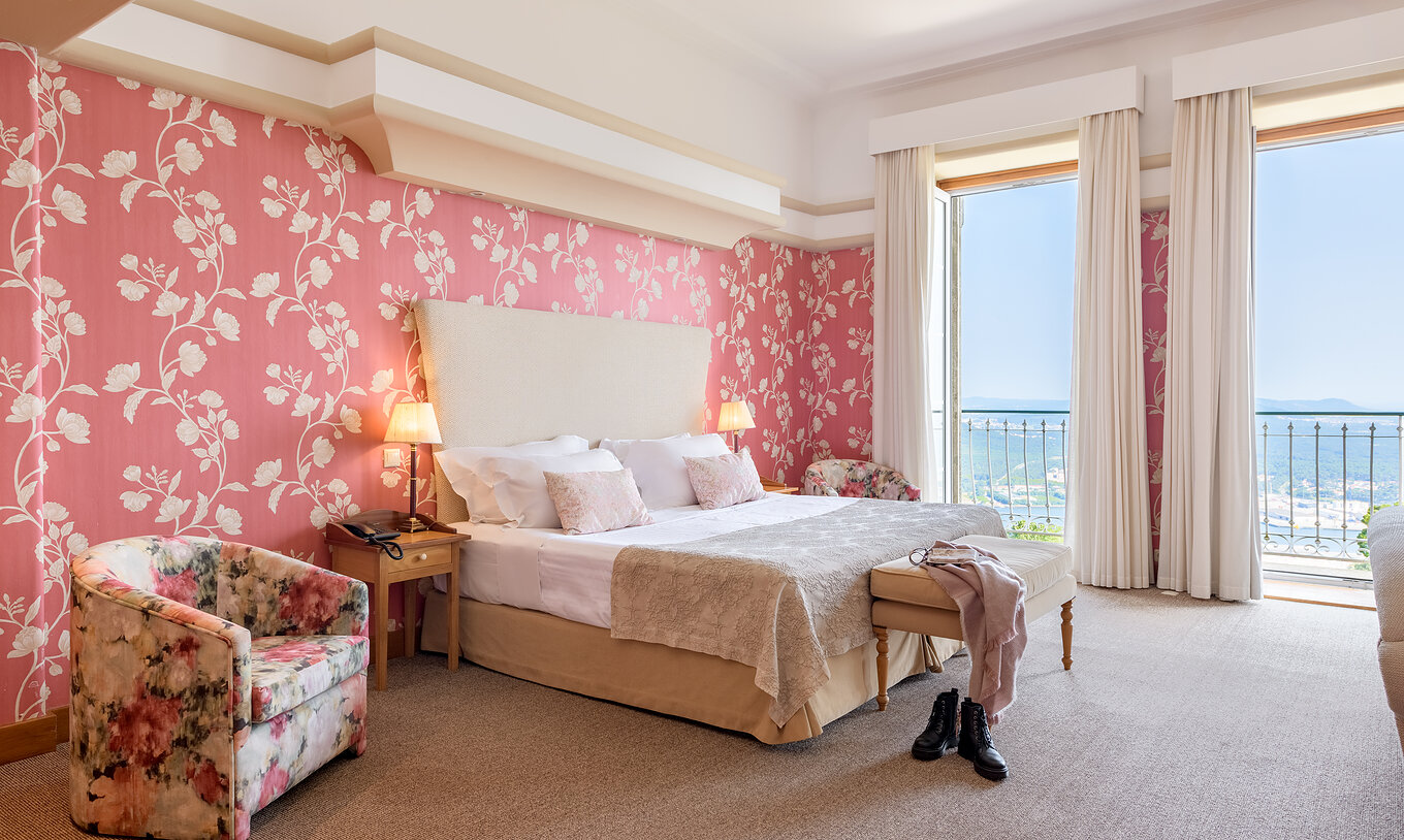 The Panoramic Suite of The Pousada Viana do Castelo has two windows next to the bed with a view of Viana do Castelo