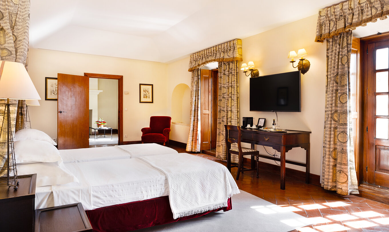 The Master Suite of The Pousada Convento Vila Viçosa has two joined beds with a television