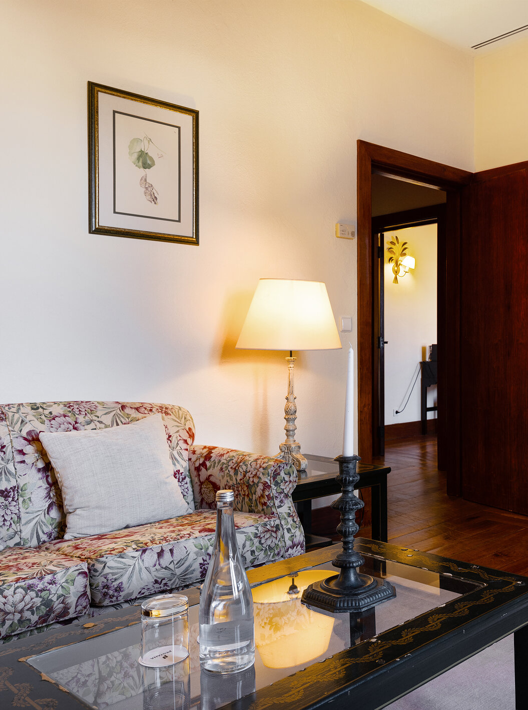 The Special Suite of The Pousada Convento Vila Viçosa has a living room with a sofa, a coffee table, and a bottle of water