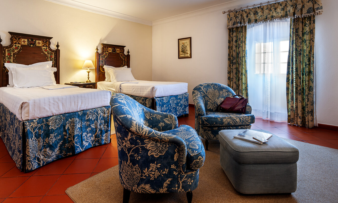The Superior Double of The Pousada Marvão features two separate beds and two matching armchairs