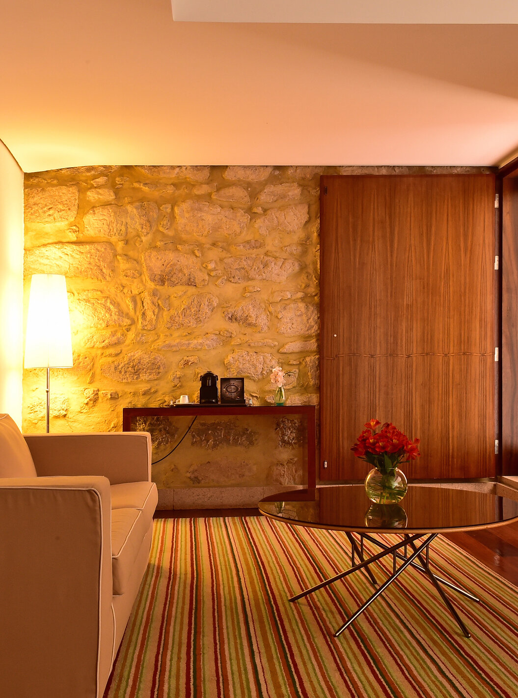 The Standard Suite of The Pousada Mosteiro Crato has a sofa with a small table in the center and a view of the balcony