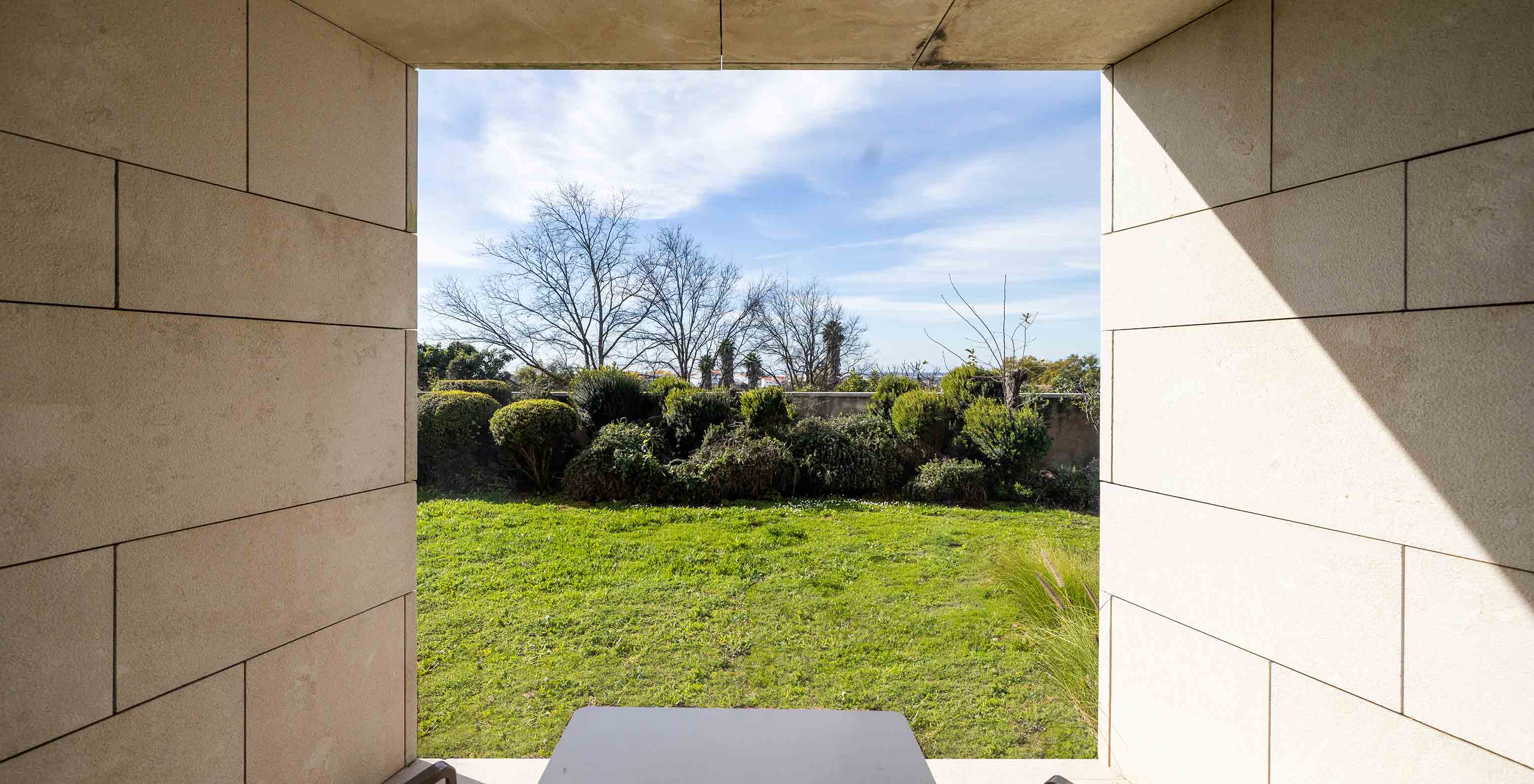 The Classic Room at Pousada Palácio Estoi has a balcony overlooking a lawn with two chairs and a table
