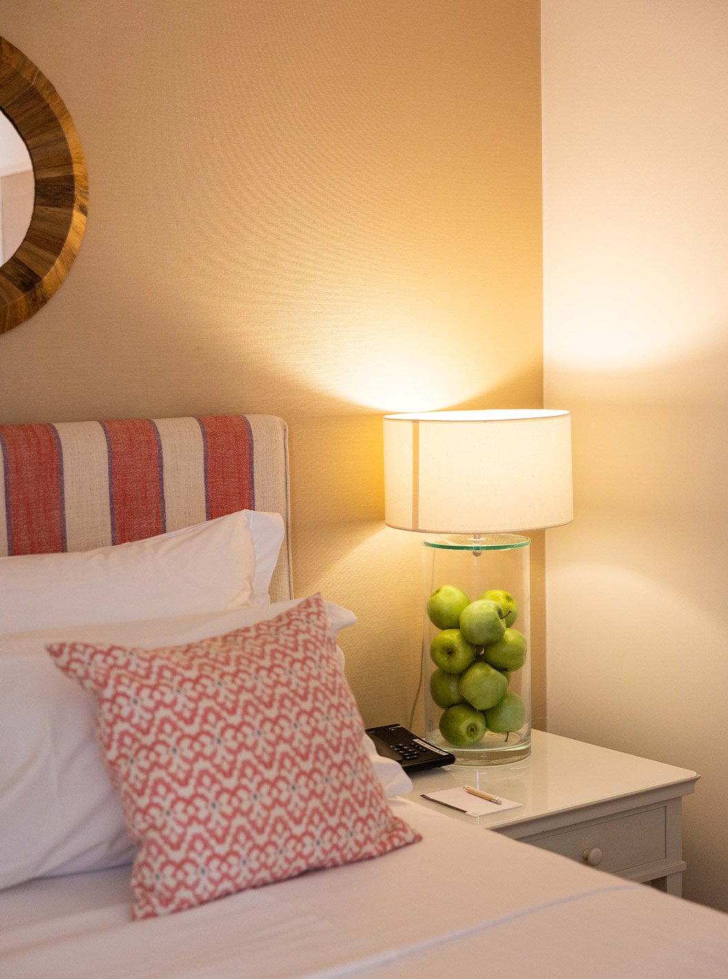 The Classic Room at Pousada Sagres has a colorful headboard and a lamp with green apples inside