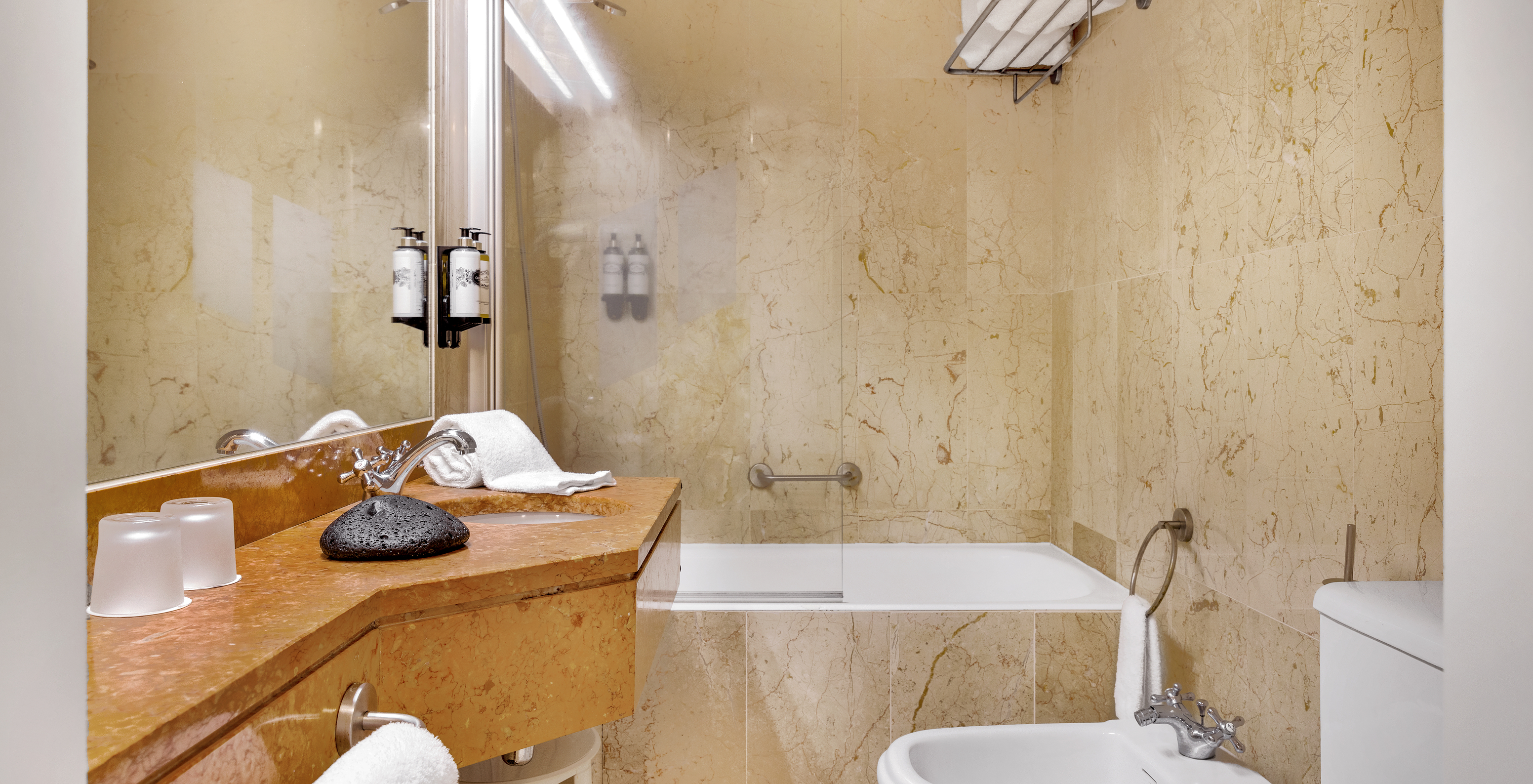 The Classic Room of The Pousada Forte Horta has a bathroom with sink, bathtub with shower, and towel