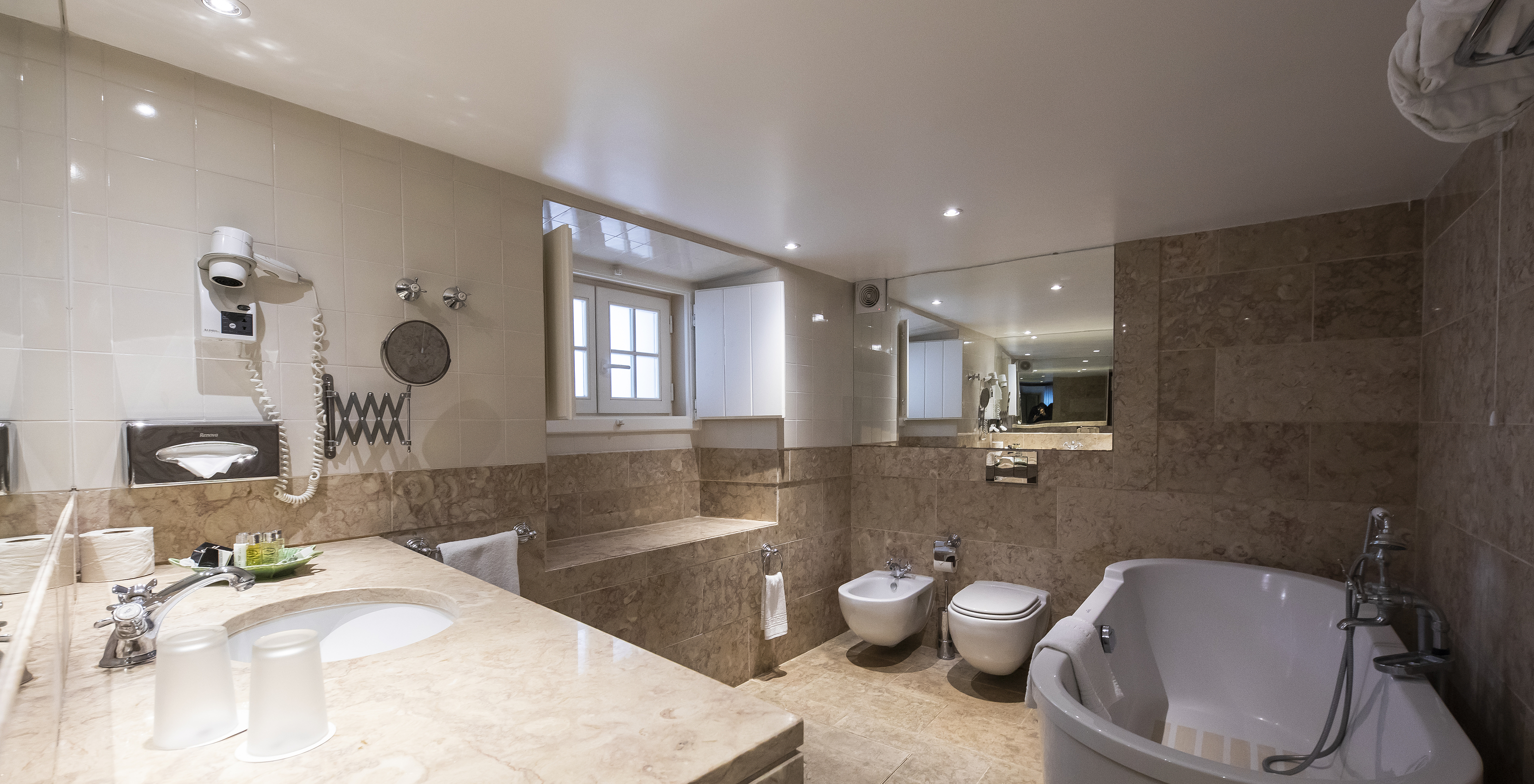 The Standard Cottage at Pousada Castelo Óbidos has a bathroom with sink, hairdryer, toilet, and bathtub