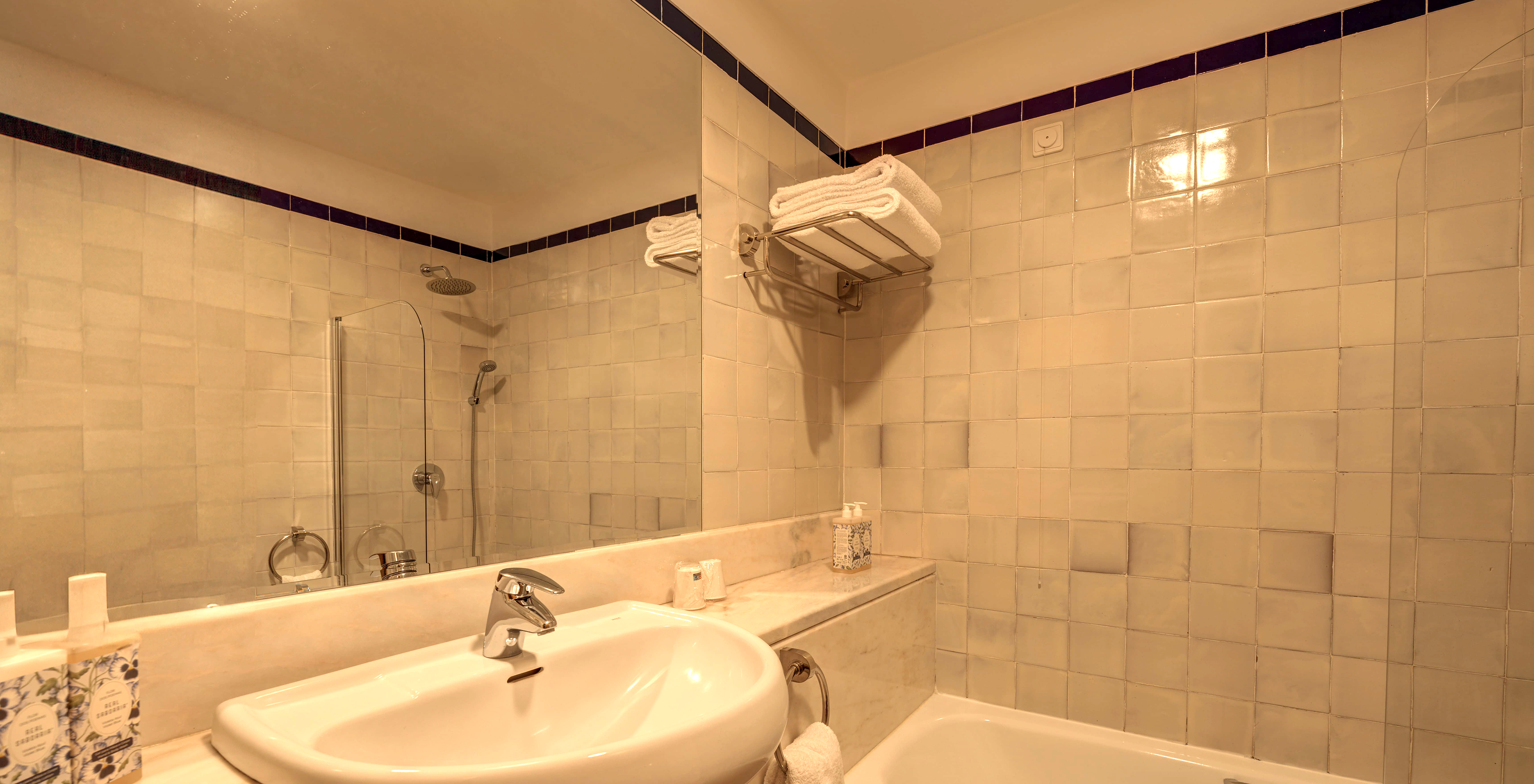 The Superior Family Room of The Pousada Ourém has a bathroom with a sink, a large mirror, and a bathtub