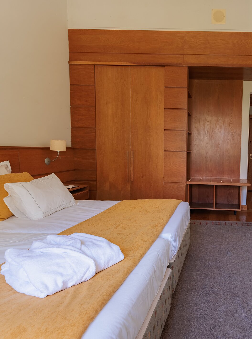 The Suite of The Pousada Ourém features a double bed with a wardrobe beside it and a television in front of the bed