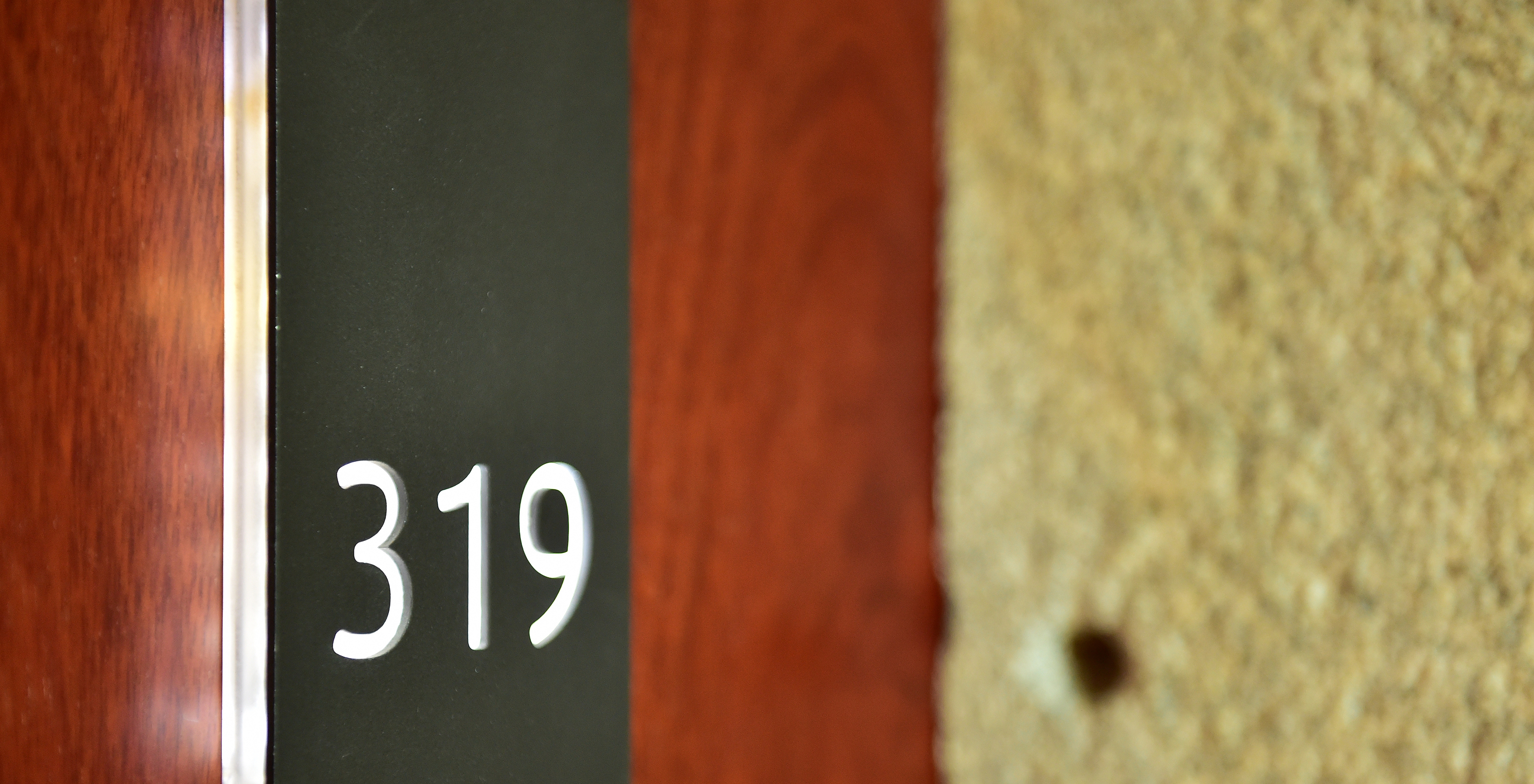 The Classic Family of the Pousada Viseu has a room door made of wood, with stone around