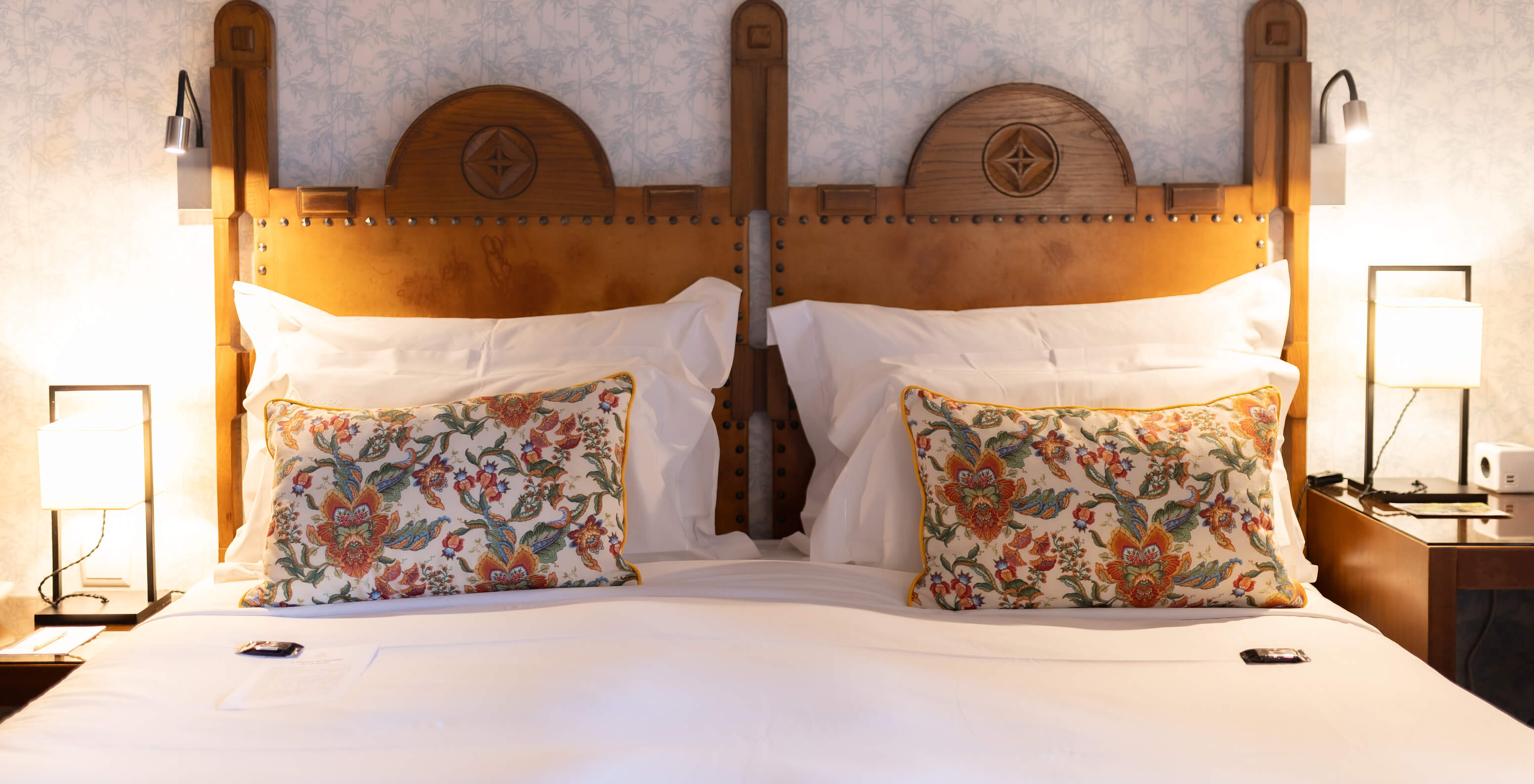 The Standard Suite at Pousada Caniçada - Gerês has a double bed with a wooden headboard and floral wallpaper
