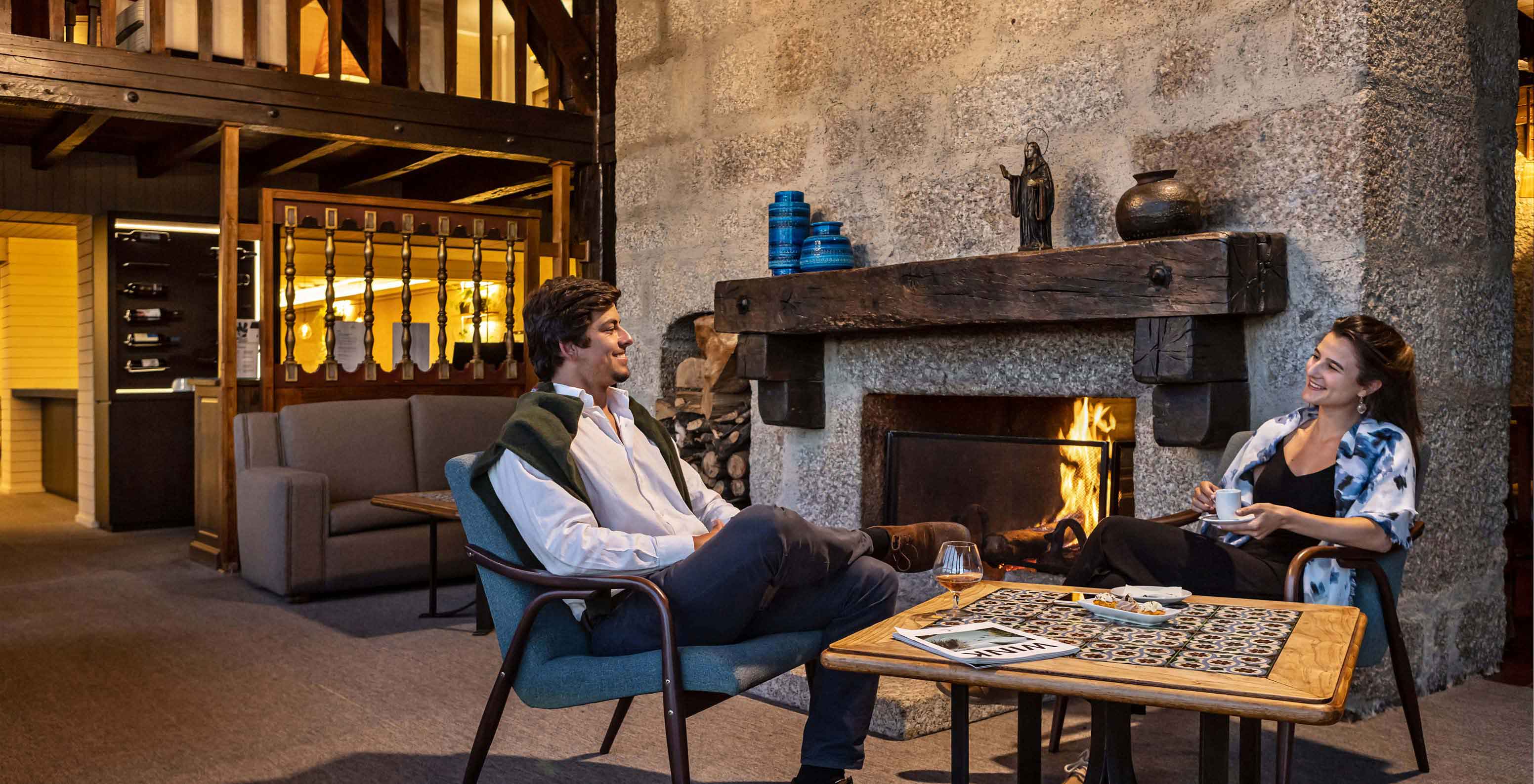 Guests enjoy the fireplace while having coffee at Pousada Caniçada - Gerês, Mountain Hotel in Gerês