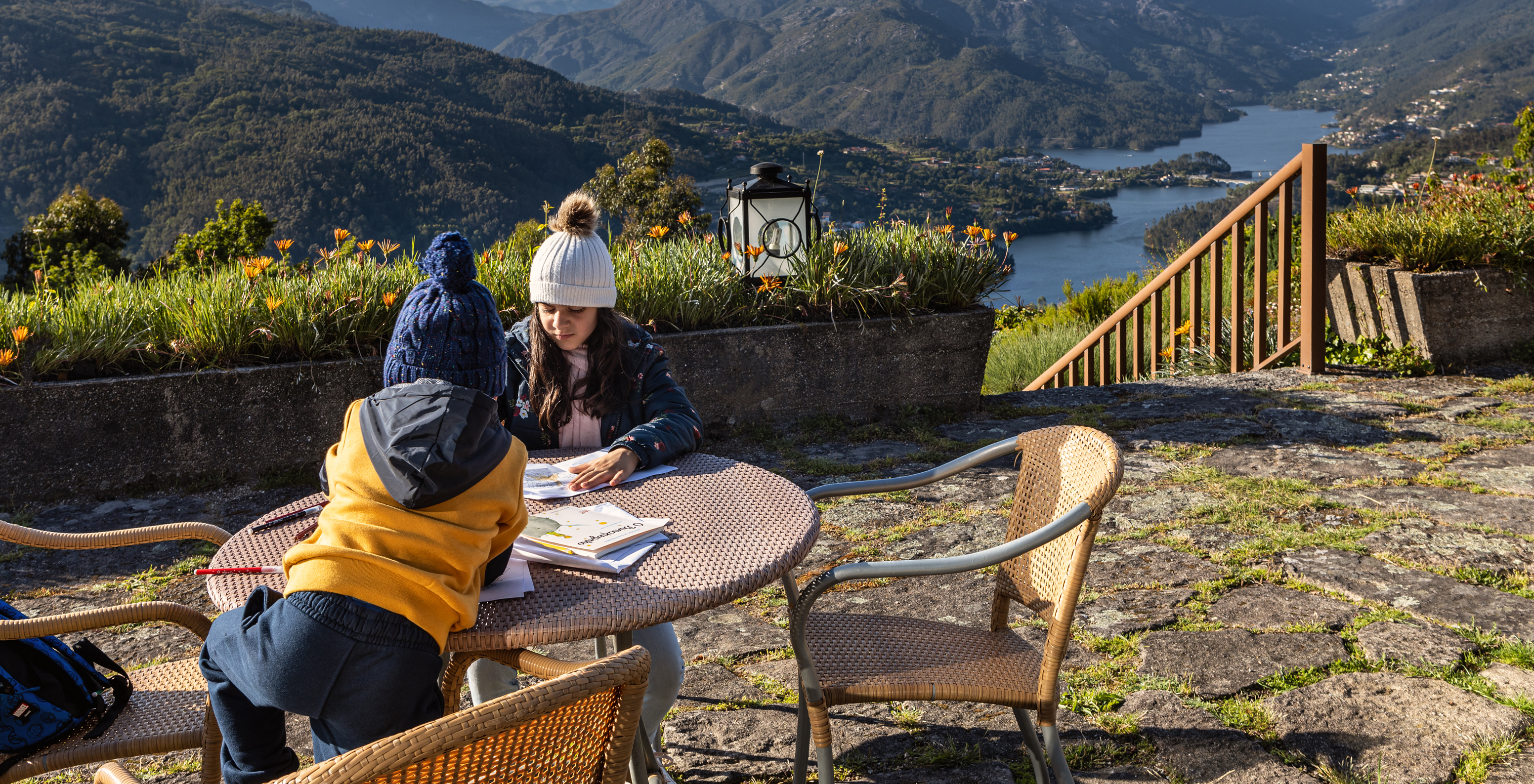 Two children playing on the terrace at Pousada Caniçada - Gerês, with views of the Douro River and mountains