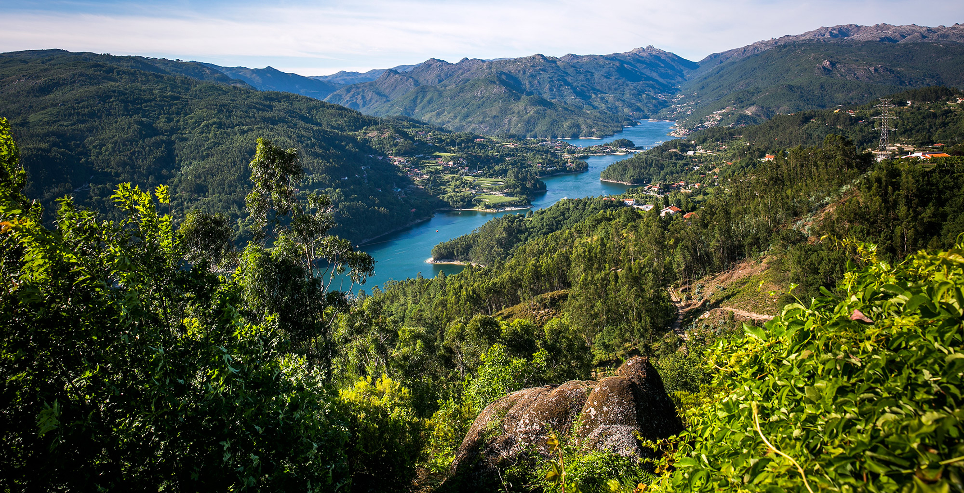View of Pousada Caniçada - Gerês, with lush greenery and a valley of mountains with the Douro River in the middle