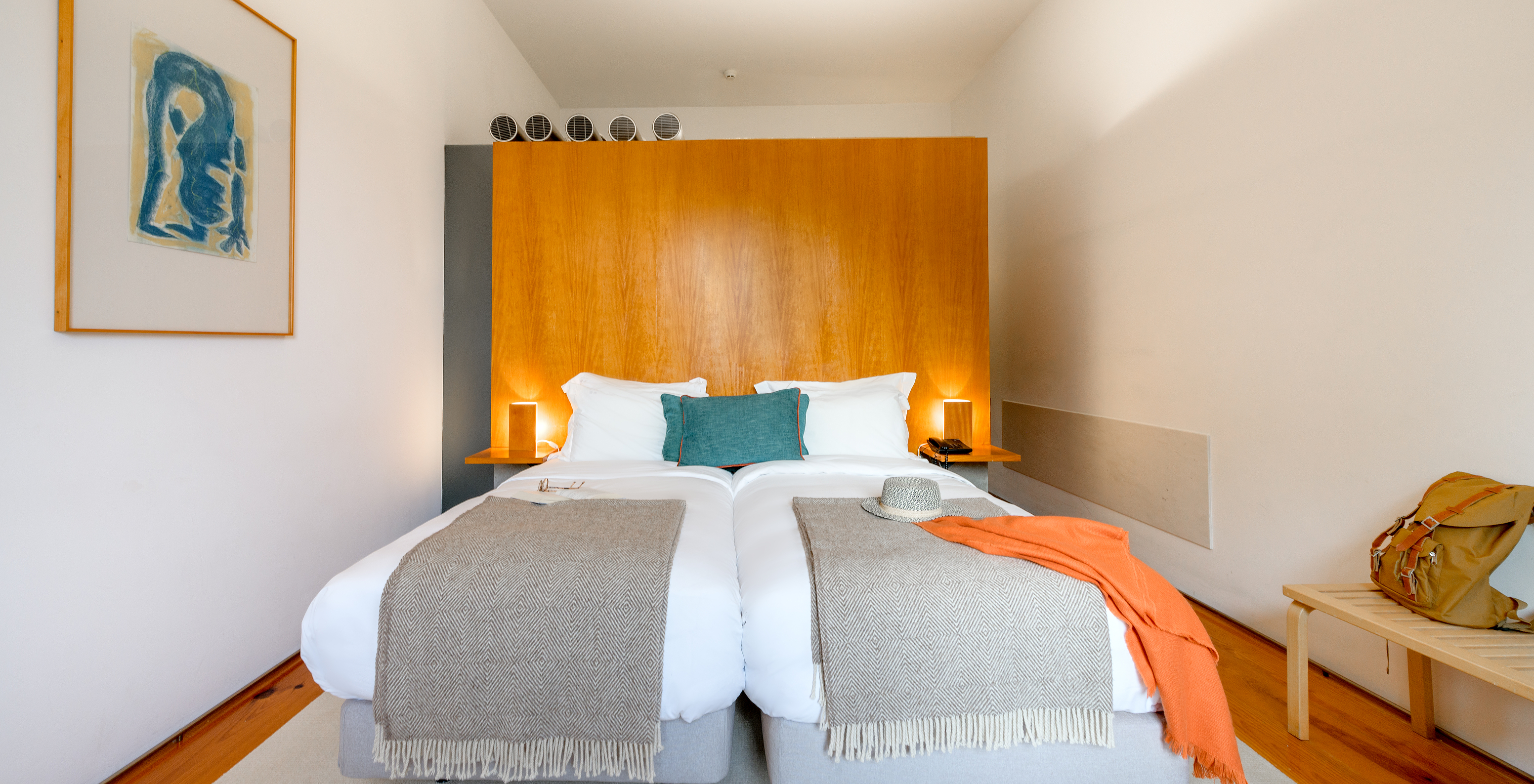 The Family Classic of The Pousada Mosteiro Amares features two separate beds with a tall wooden headboard and blue cushions