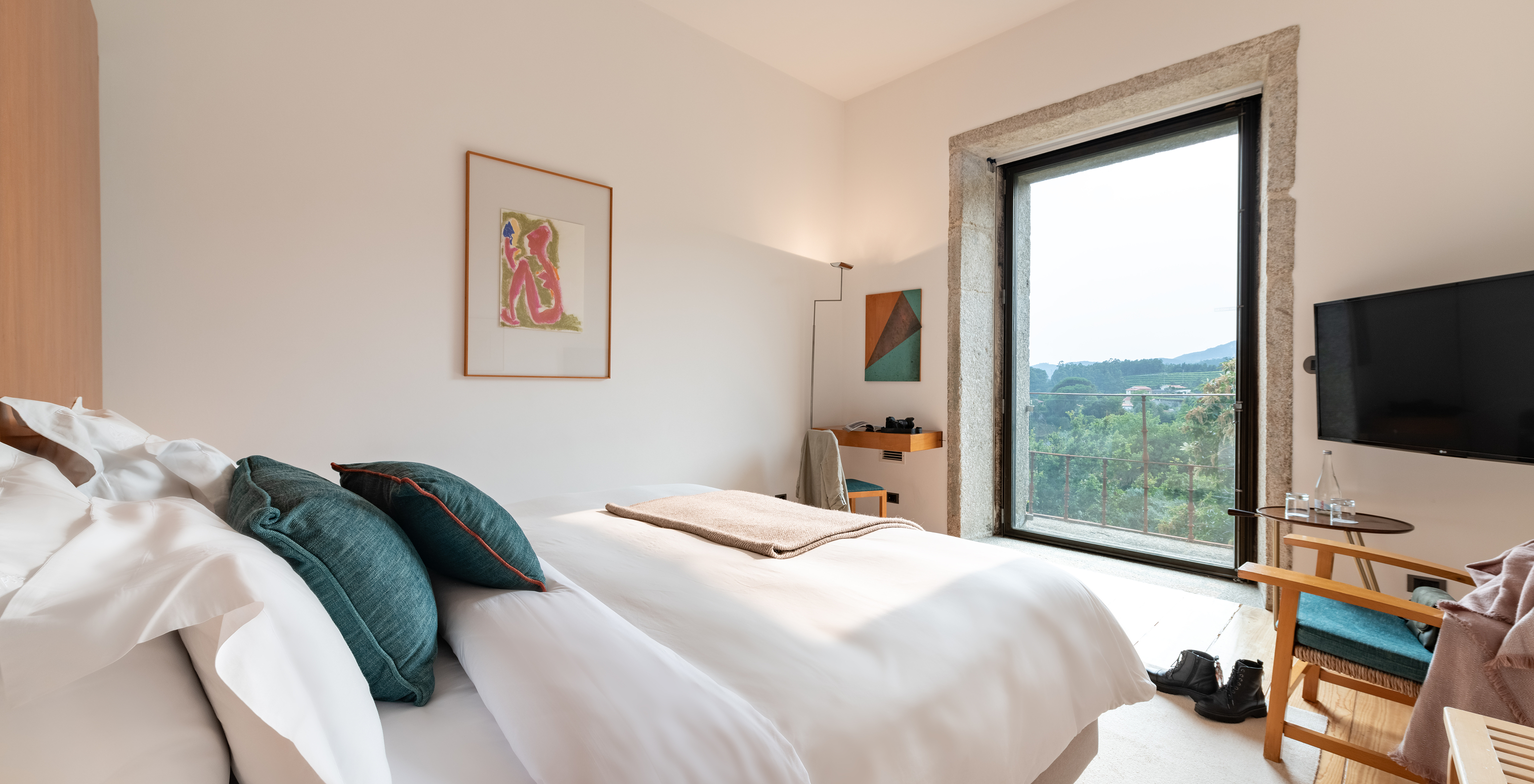 The Superior Room of The Pousada Mosteiro Amares features a double bed, a window with a view of nature, and a television