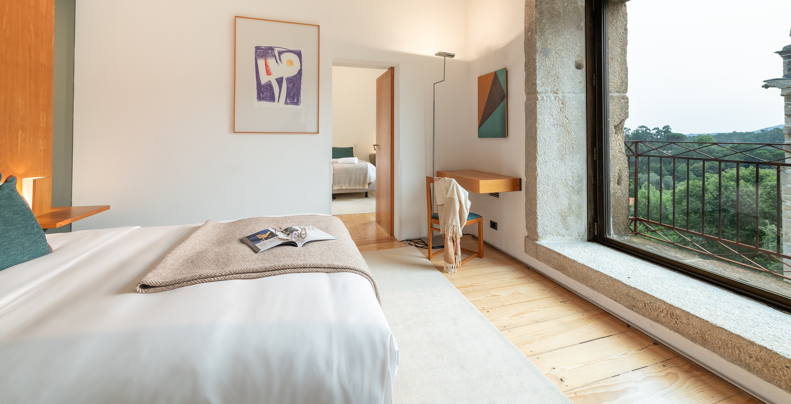 The Superior Room of The Pousada Mosteiro Amares features two beds and a large window with a view of nature