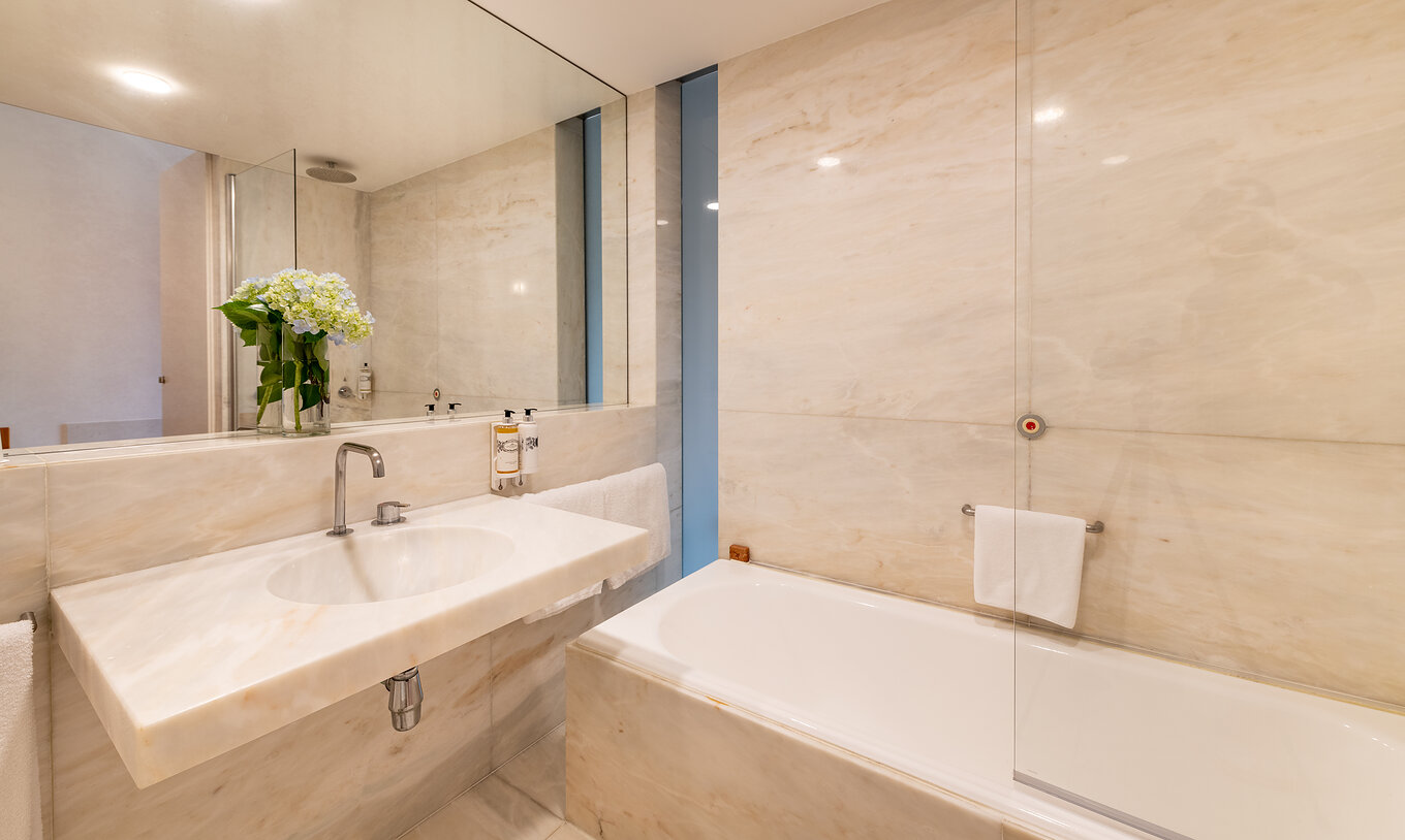 The Large Family of The Pousada Mosteiro Amares features a marble bathroom with a bathtub and sink