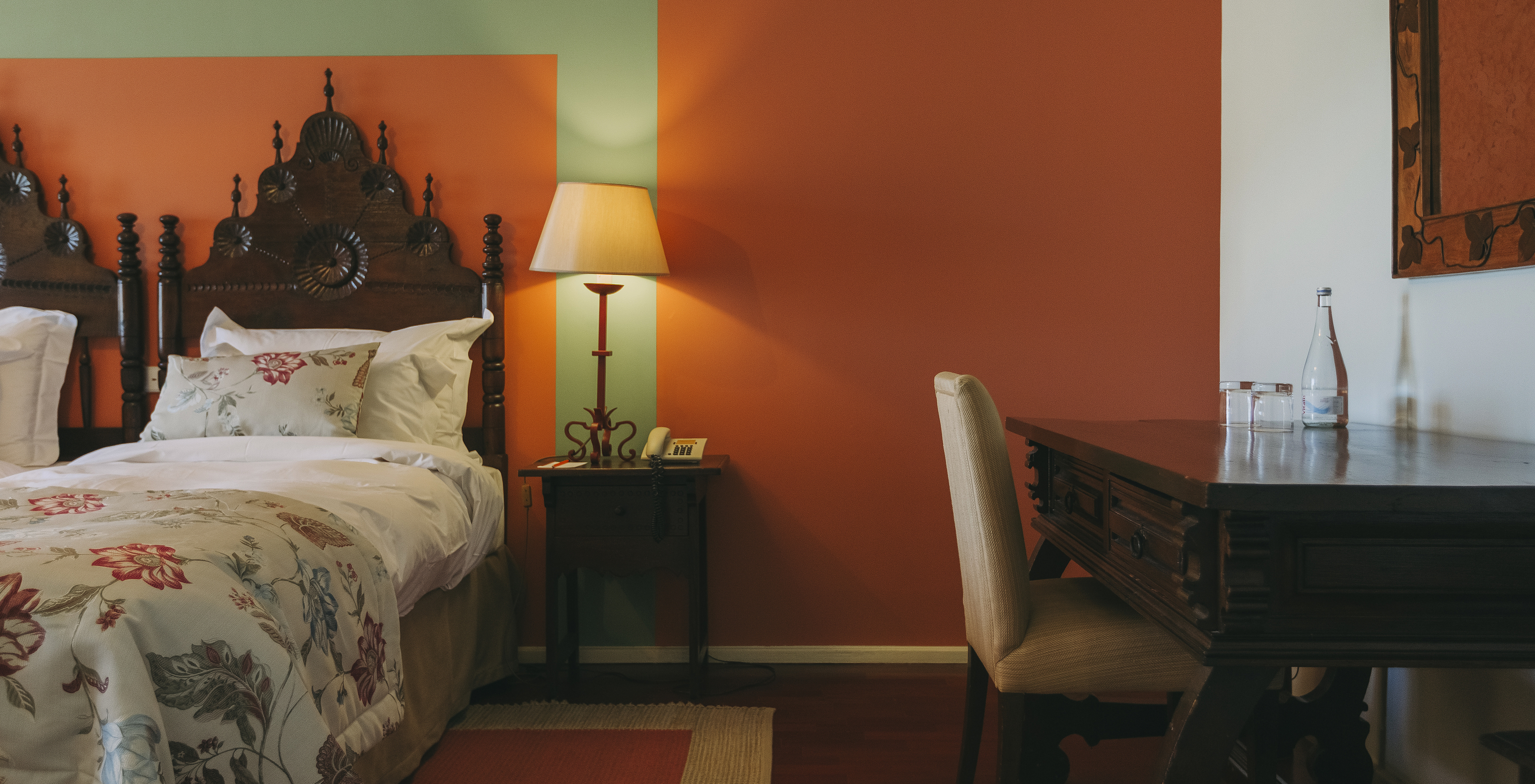 The Large Family Suite of The Pousada Valença has two separate beds with a wooden headboard and a desk