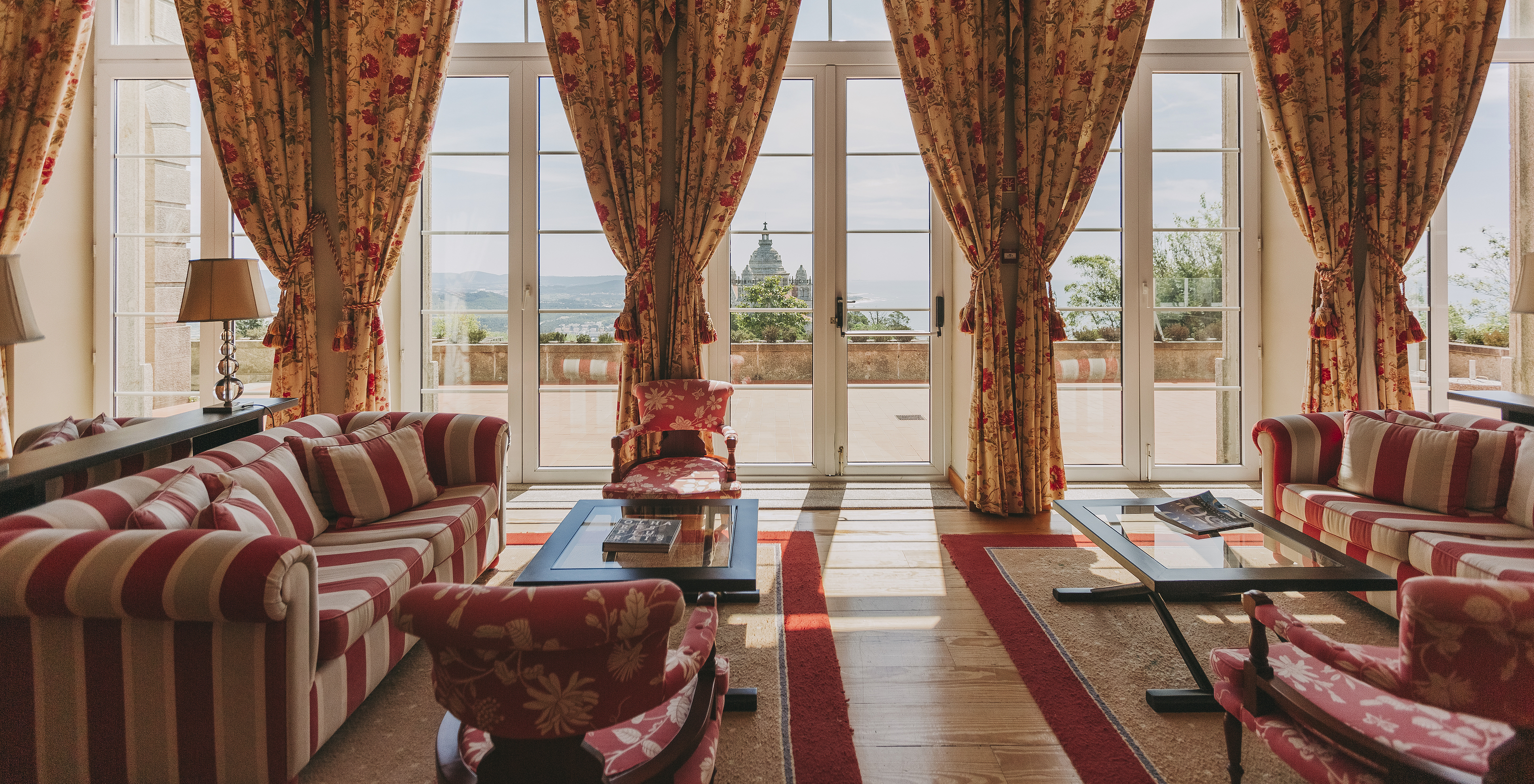 View of the Basilica from the living room of the hotel in Monte de Santa Luzia with several windows leading to a balcony