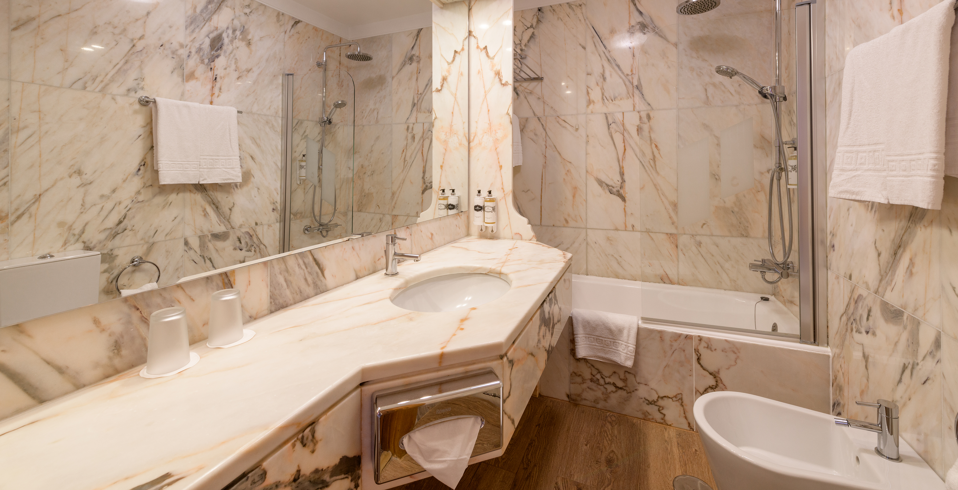The Standard Suite of The Pousada Viana do Castelo has a bathtub with a shower and a counter with a marble sink