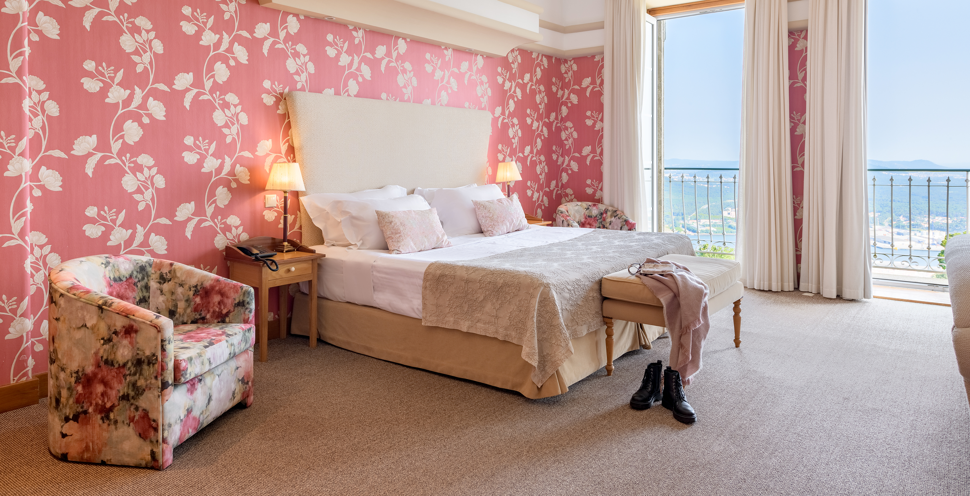The Standard Suite of The Pousada Viana do Castelo has two windows next to the bed with a view of Viana do Castelo