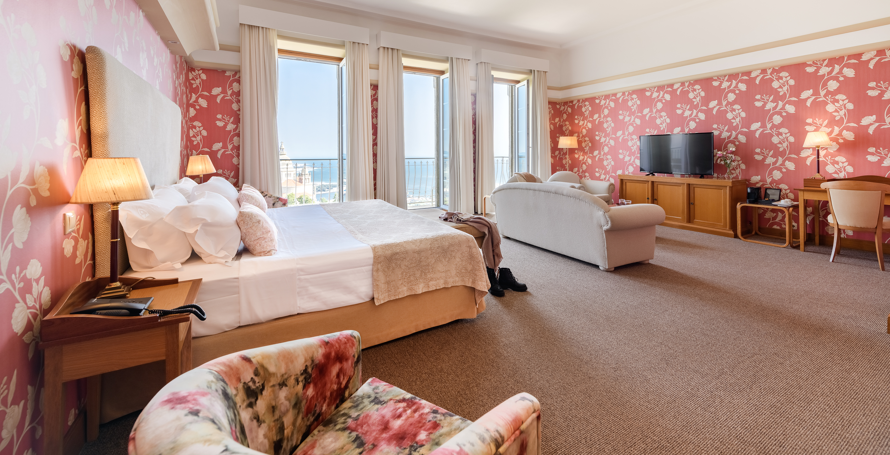 The Standard Suite of The Pousada Viana do Castelo has three windows, a sofa, and a television where you can relax