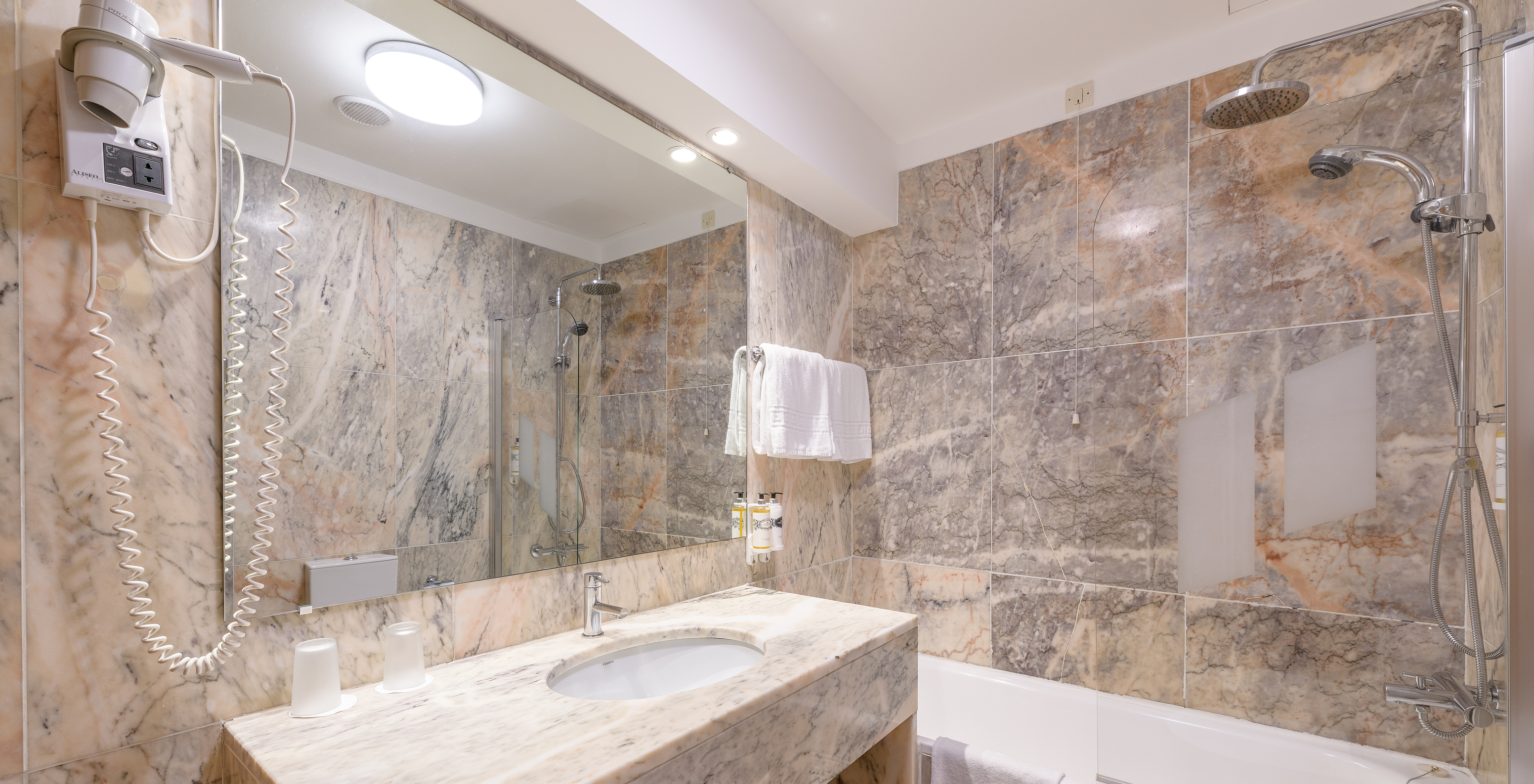 The Superior Family of The Pousada Viana do Castelo has a bathtub with a shower and a counter with a marble sink