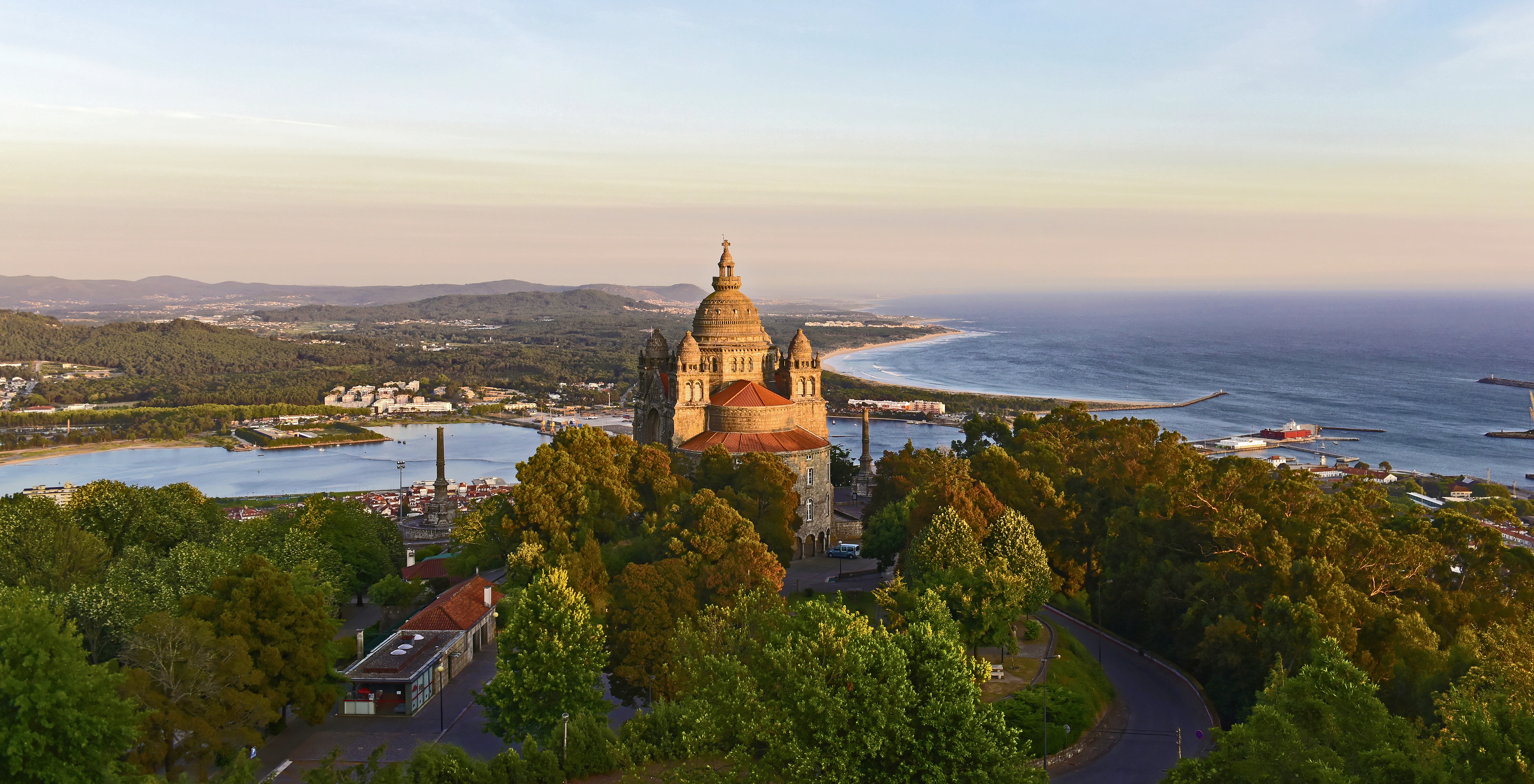 Aerial view of Basilica of Santa Luzia near Pousada Viana do Castelo with trees, ocean