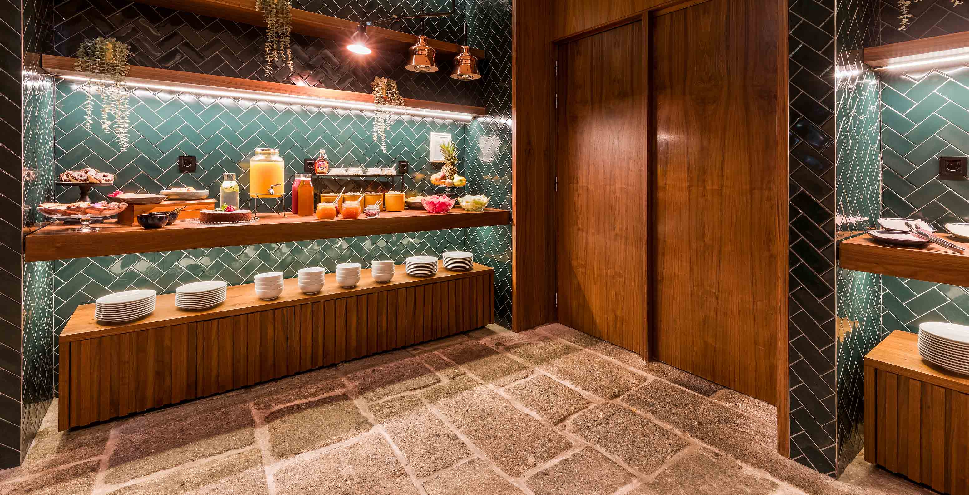 The Pousada do Porto, a hotel in the center of Porto with an indoor pool, has a tiled and stone room with a buffet breakfast.