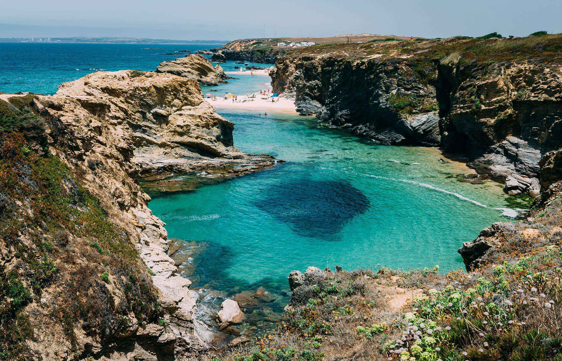 Paradijselijk landschap van Praia da Samoqueira in Alentejo, verborgen tussen kliffen en met kristalhelder water