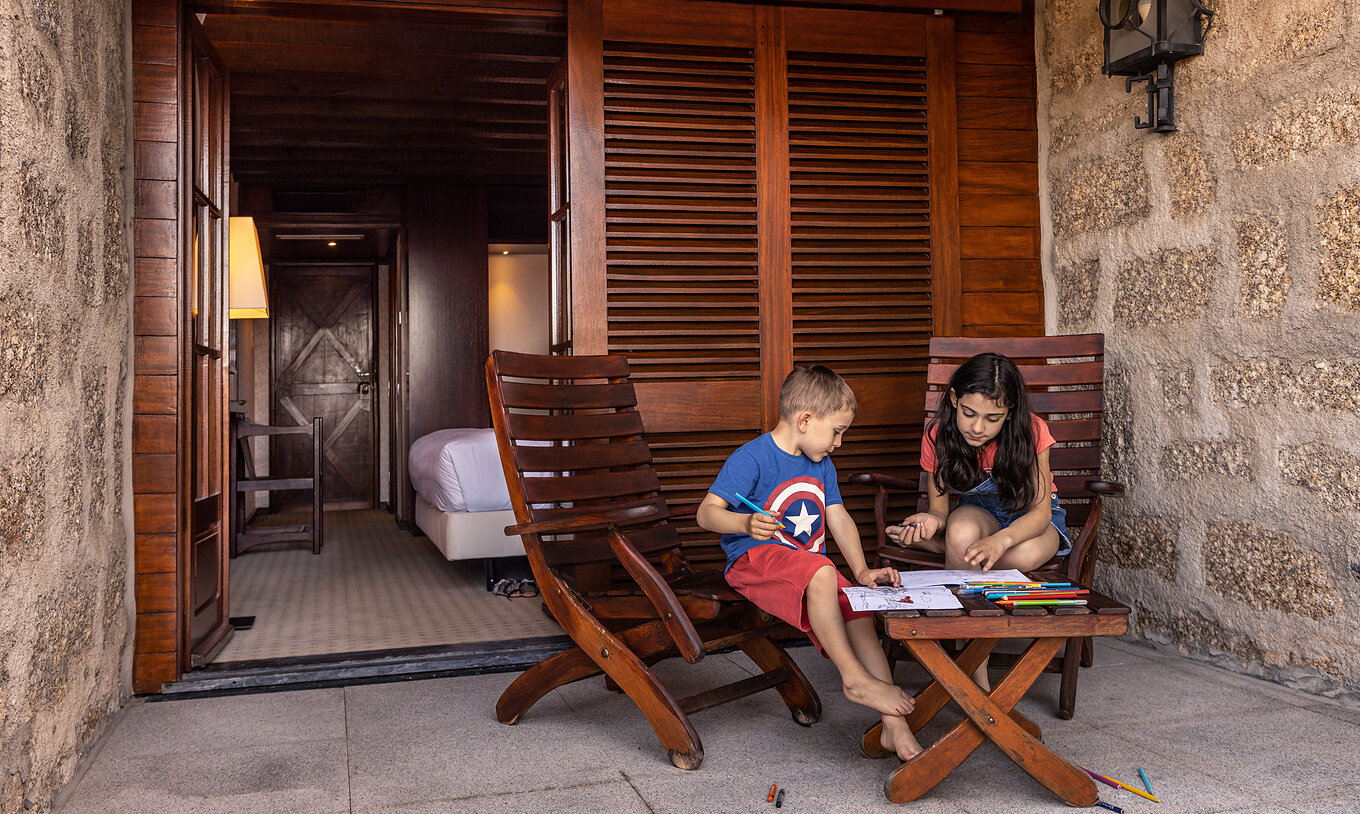 De Standaard Suite van Pousada Caniçada - Gerês heeft een balkon met tafel en stoelen, ideaal voor kinderen om te spelen