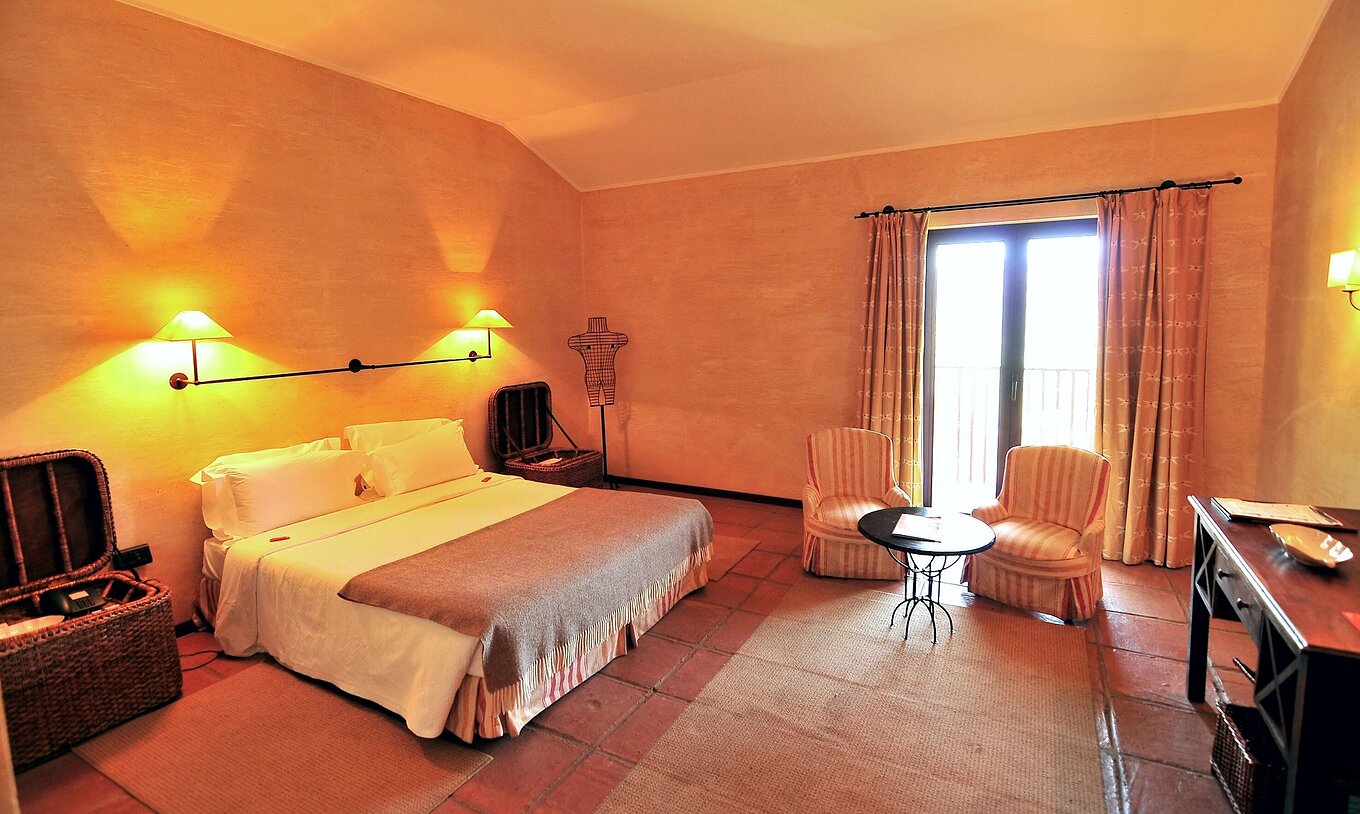 O Quarto Clássico da Pousada Convento de Belmonte tem um quarto com uma cama de casa, dois cadeirões e uma janela