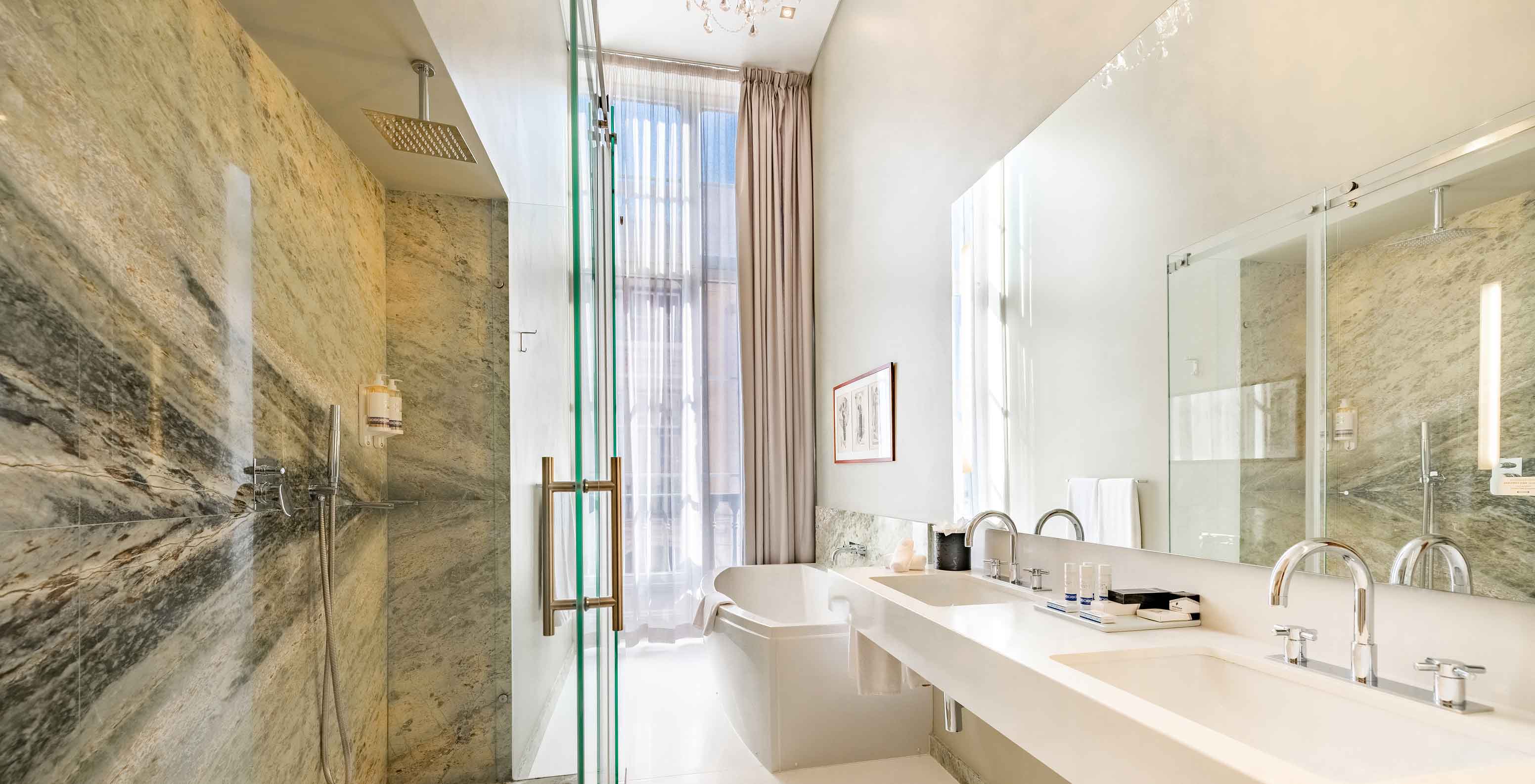 A Presidential Suite King Size Bed da Pousada Lisboa Praça do Comércio tem uma casa de banho moderna com chuveiro e banheira