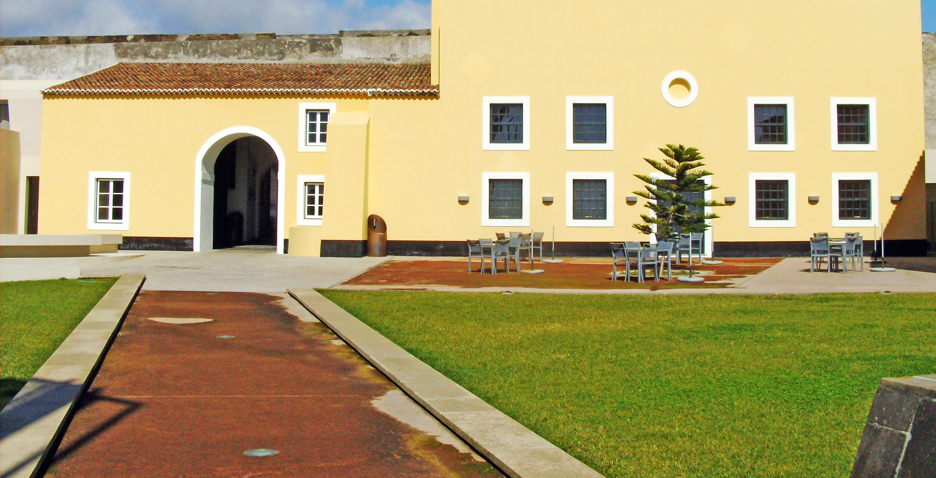 Entrada da Pousada Forte Angra do Heroísmo com uma pequena esplanada nos jardins