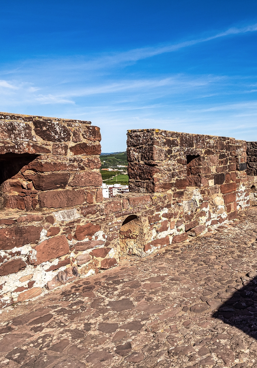 Walls of Faro Castle with stone floor covered with shadows projected by architectural elements